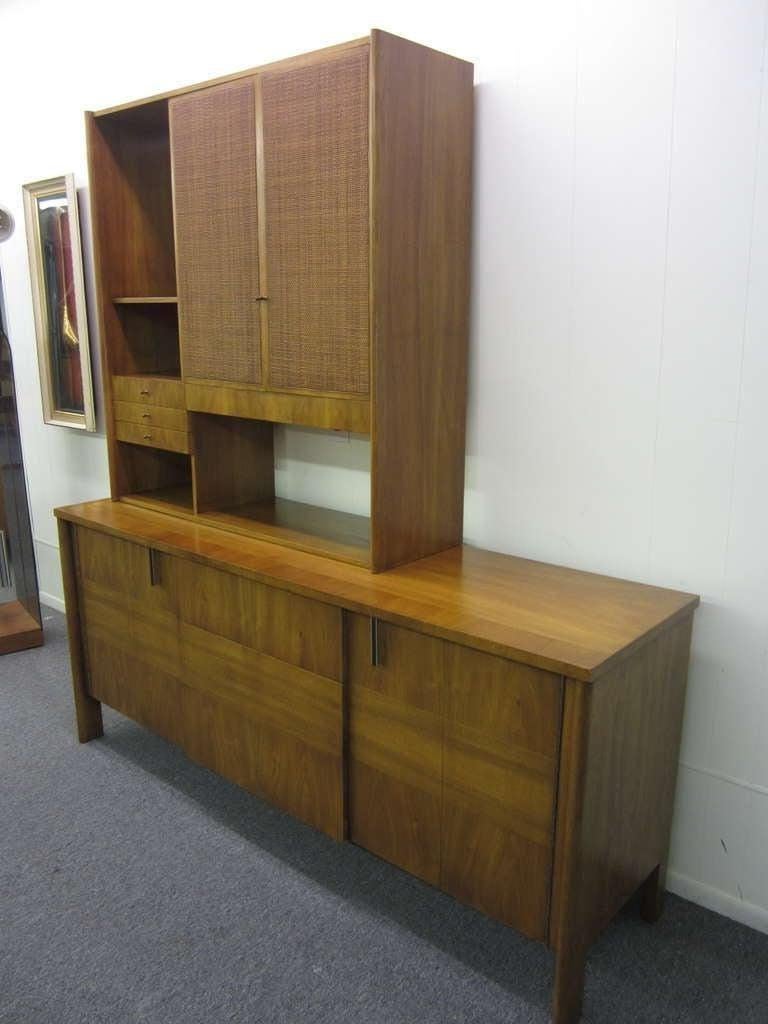 Awesome and unique buffet/hutch designed by Dale Ford.   An excellent use of grain pattern and direction create a clean and striking cabinet from the high end furniture maker John Widdicomb. The cane front doors and open back of the upper piece