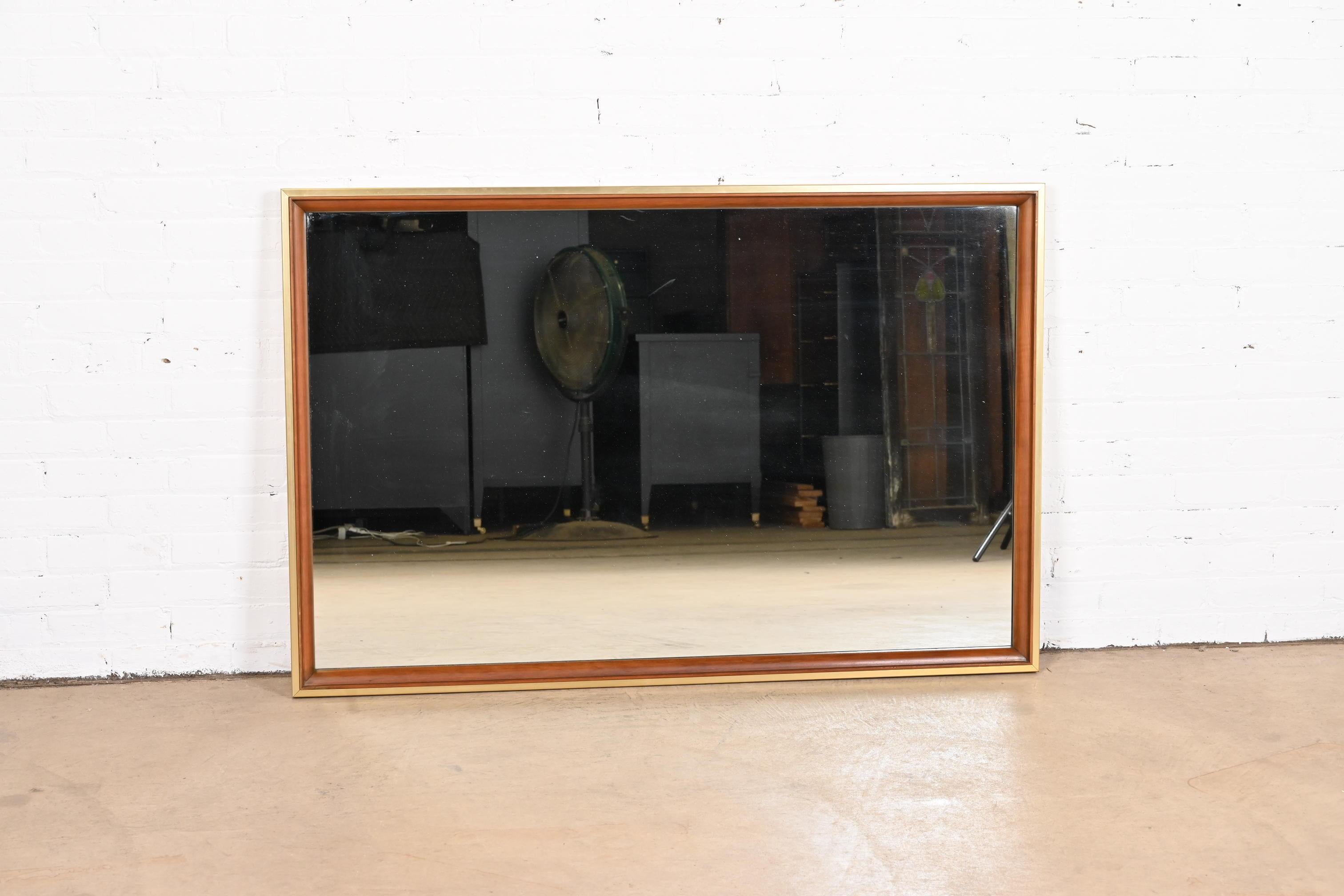 A gorgeous Mid-Century Modern cherry wood and brass framed wall mirror

By John Widdicomb

USA, 1950s

Measures: 52.5