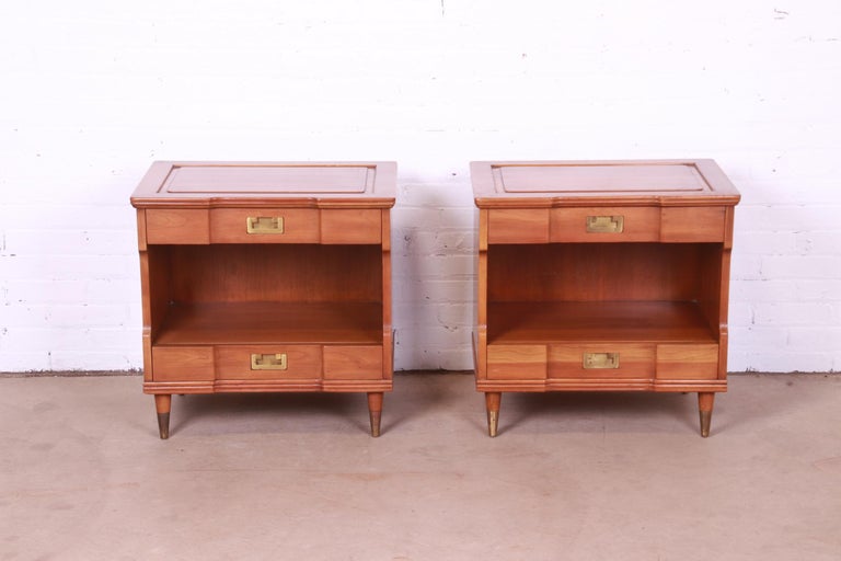 An exceptional pair of Mid-Century Modern Campaign style nightstands.

By John Widdicomb

USA, Circa 1960s

Solid cherry wood, with original brass hardware and brass-capped tapered feet.

Measures: 25