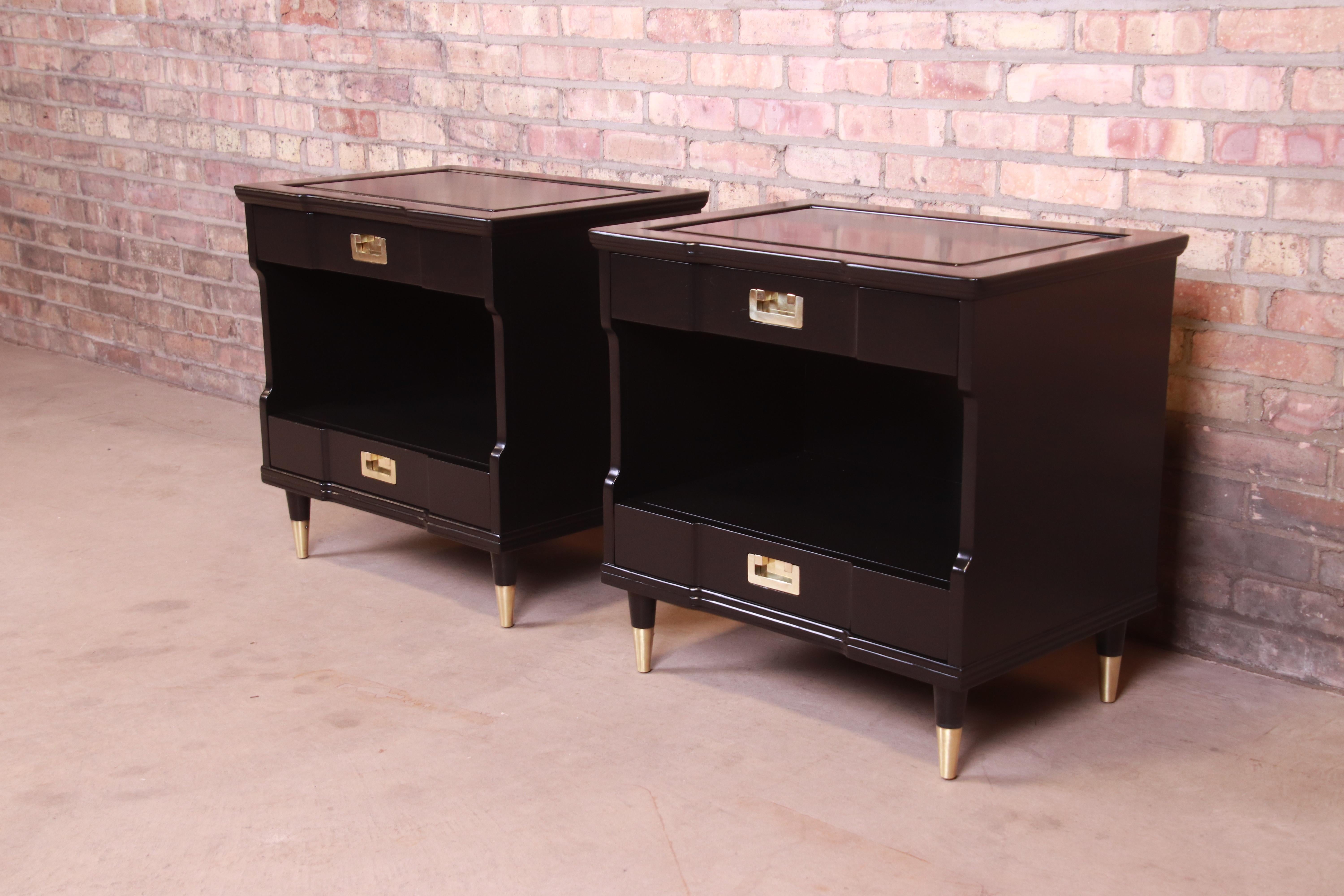An exceptional pair of Mid-Century Modern Hollywood Regency nightstands

By John Widdicomb

USA, 1950s

Black lacquered solid cherry, with original brass hardware and brass-capped tapered feet.

Measures: 25