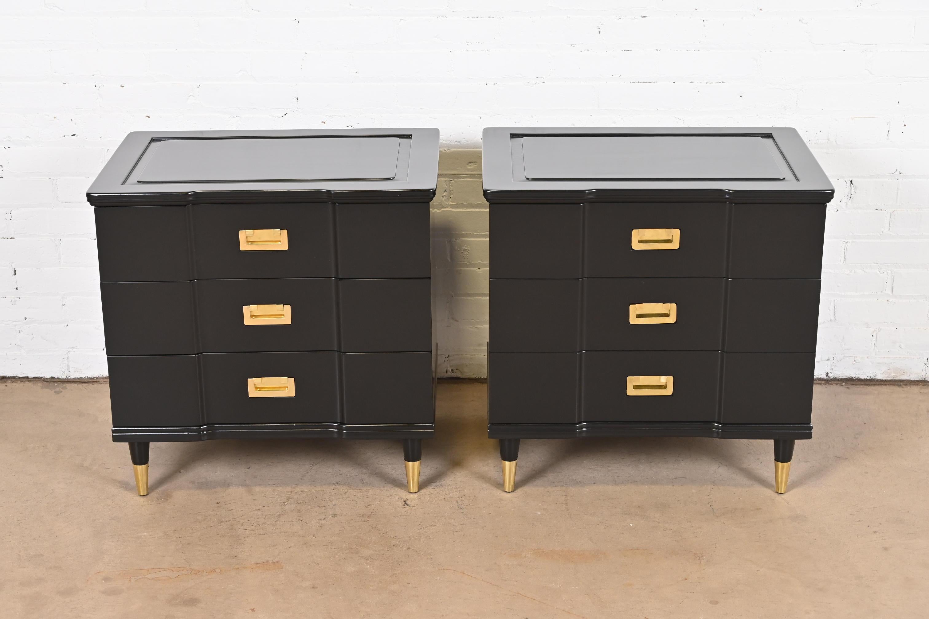 An exceptional pair of Mid-Century Modern Hollywood Regency Campaign style three-drawer bedside chests

By John Widdicomb

USA, 1950s

Black lacquered solid cherry wood, with original brass hardware and brass-capped tapered feet.

Measures: