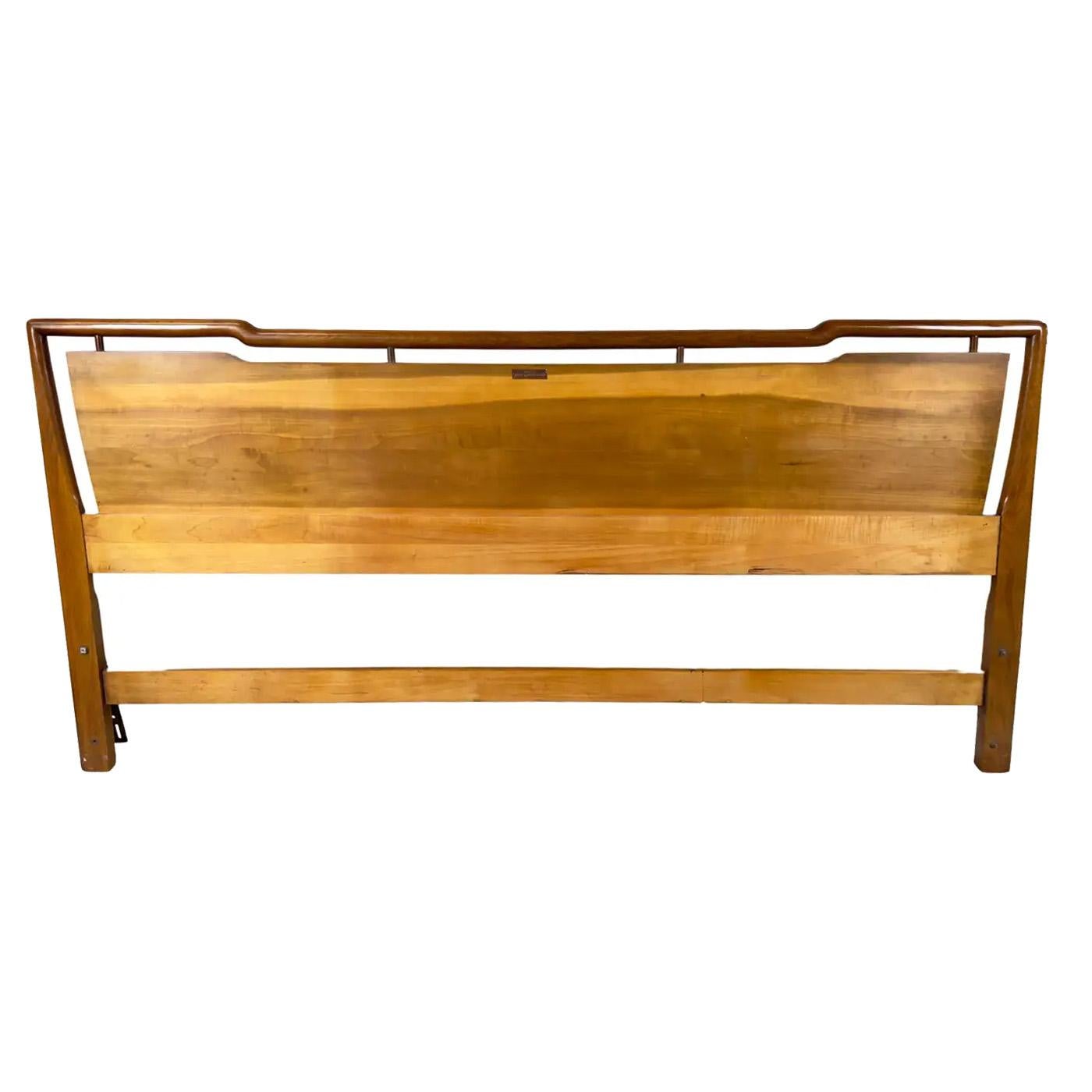 A John Widdicomb Mid Century Modern King size headboard.  Crafted from the finest walnut, this headboard boasts exquisite grains that speak to its superior quality and attention to detail. Its geometrically inspired shape adds a touch of modern
