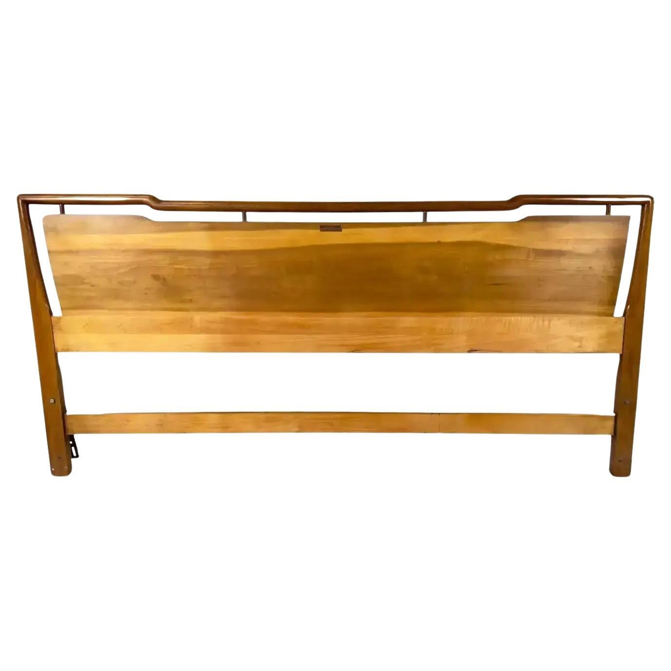 A John Widdicomb Mid Century Modern King size headboard. Crafted from the finest walnut, this headboard boasts exquisite grains that speak to its superior quality and attention to detail. Its geometrically inspired shape adds a touch of modern