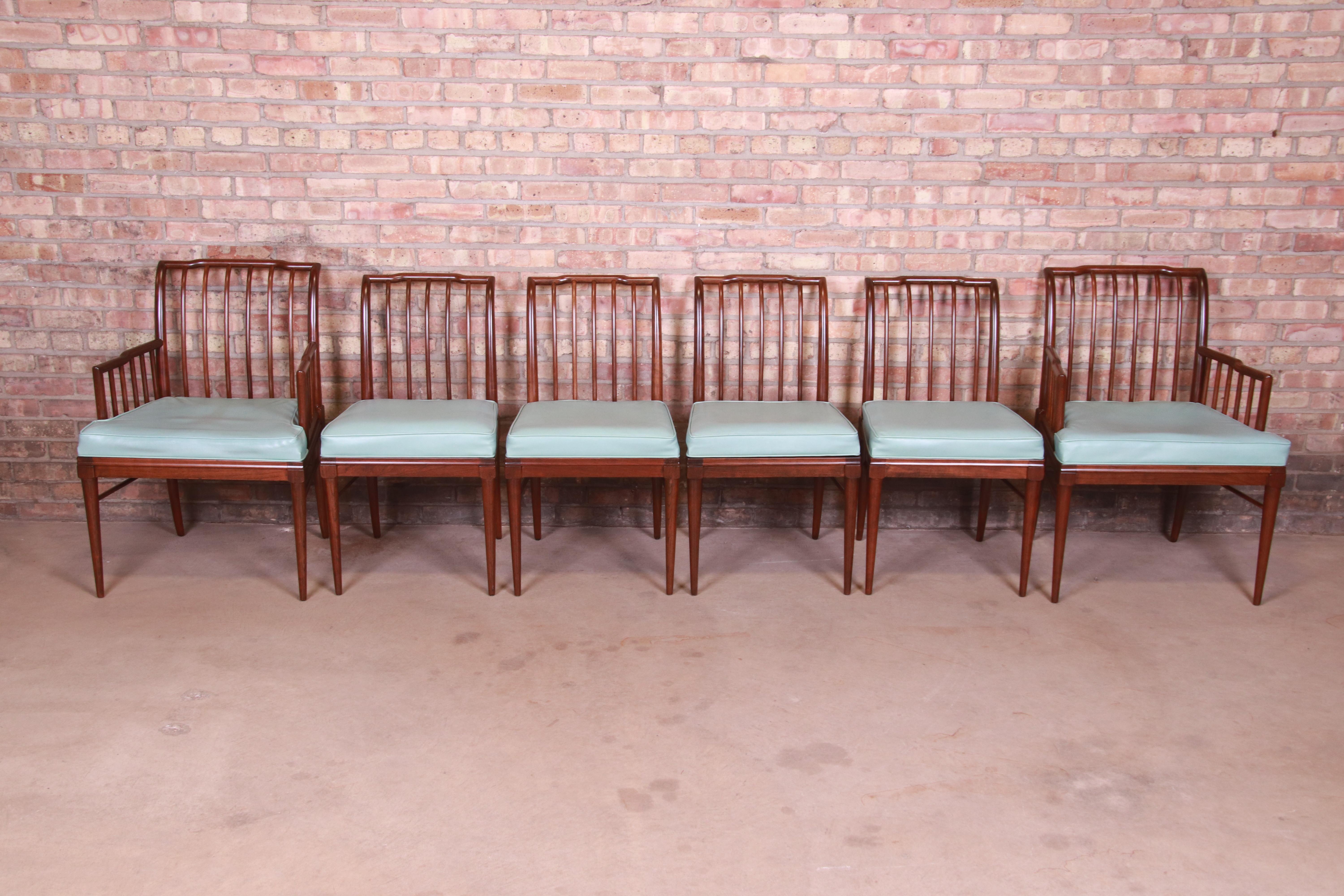 A gorgeous set of six Mid-Century Modern dining chairs

In the manner of T.H. Robsjohn-Gibbings

By John Widdicomb

USA, circa 1950s

Sculpted walnut, with original light blue vinyl upholstered seats.

Measures:
Armchairs - 24