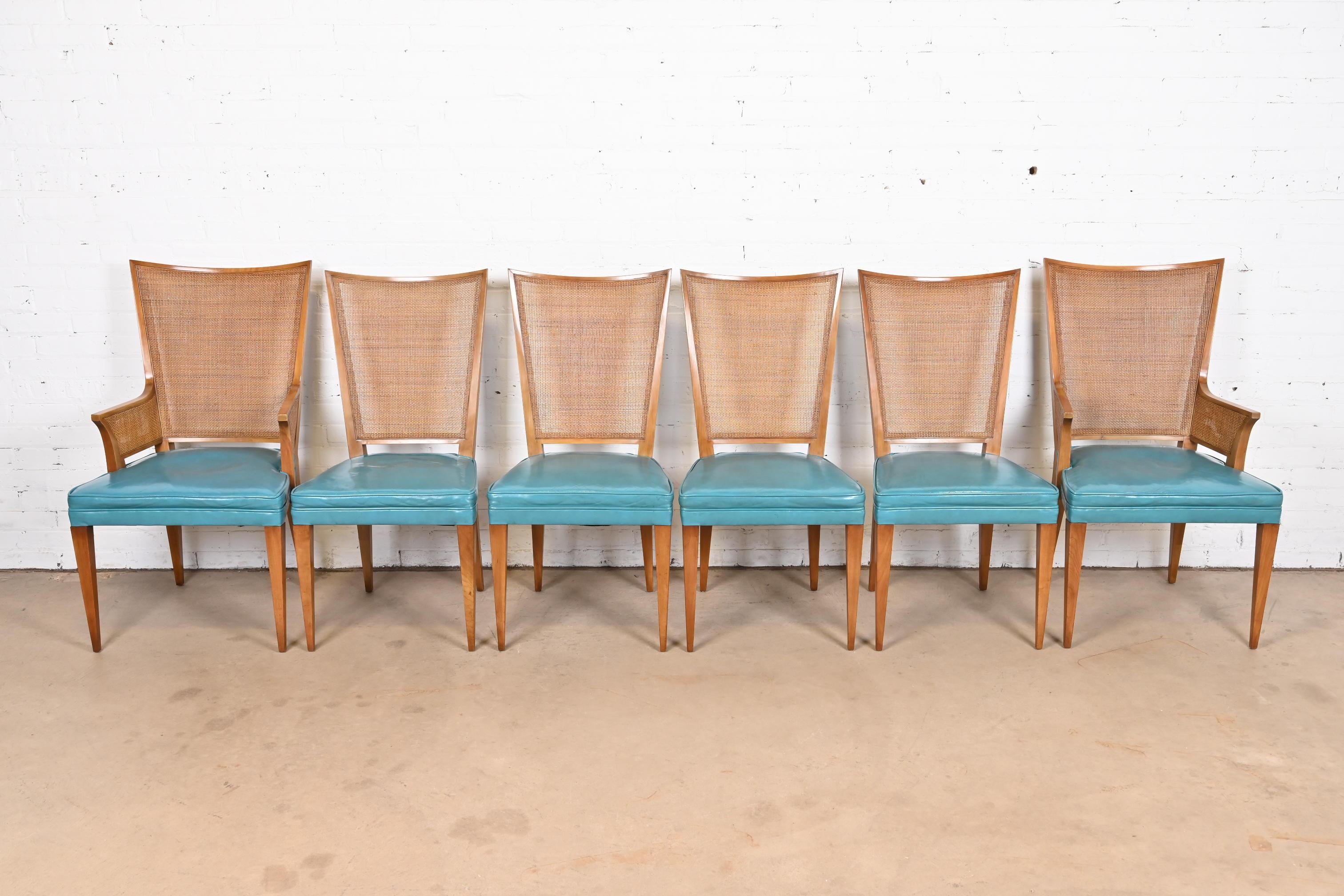 A beautiful set of six Mid-Century Modern dining chairs

By John Widdicomb

USA, Circa 1950s

Solid sculpted walnut frames, with caned seat backs and teal vinyl upholstered seats.

Measures: 
Side chairs - 19.5