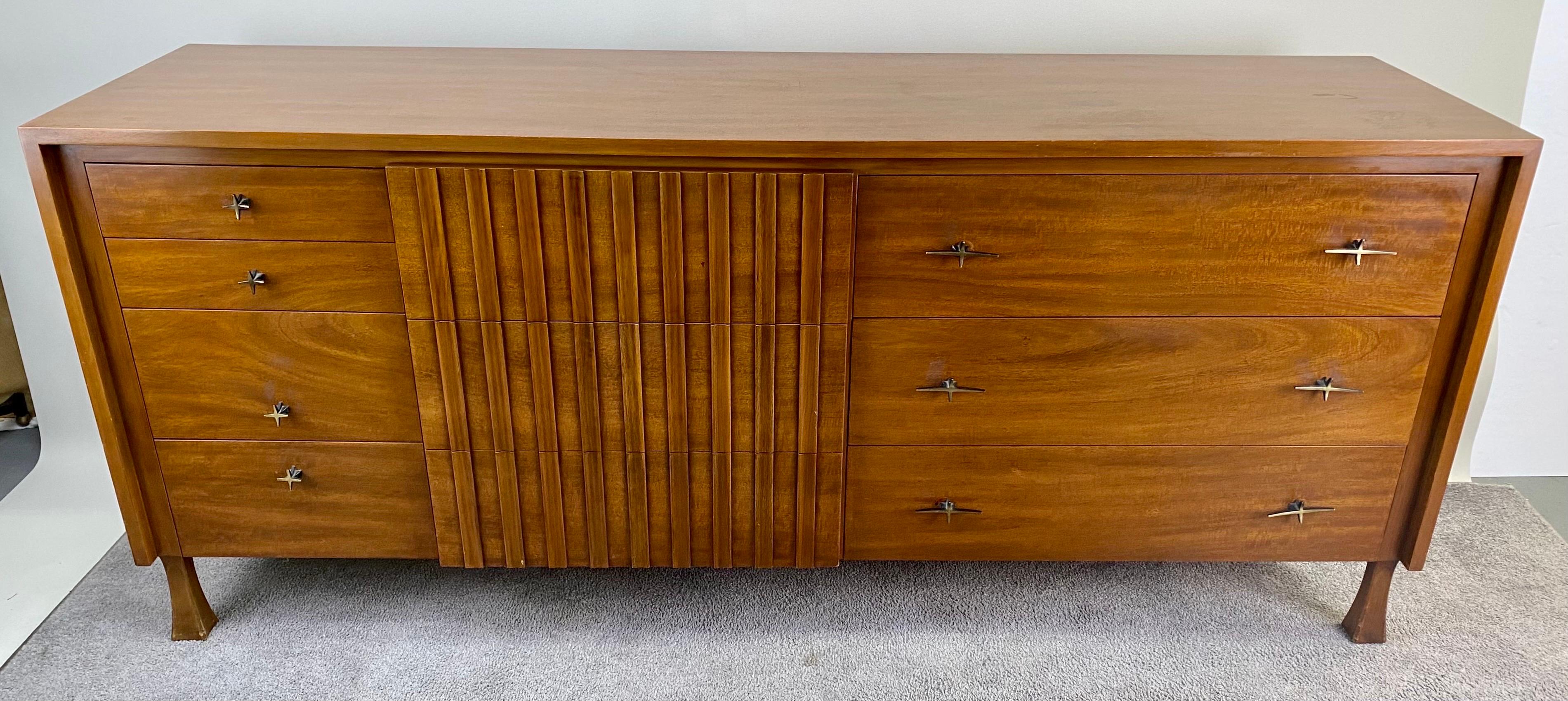 A rare John Widdicomb Mid-Century Modern low boy large dresser or credenza. Crafted with precision from high-quality walnut, this dresser stands as a testament to the enduring allure of Mid Century Modern aesthetics. Boasting a generous offering of