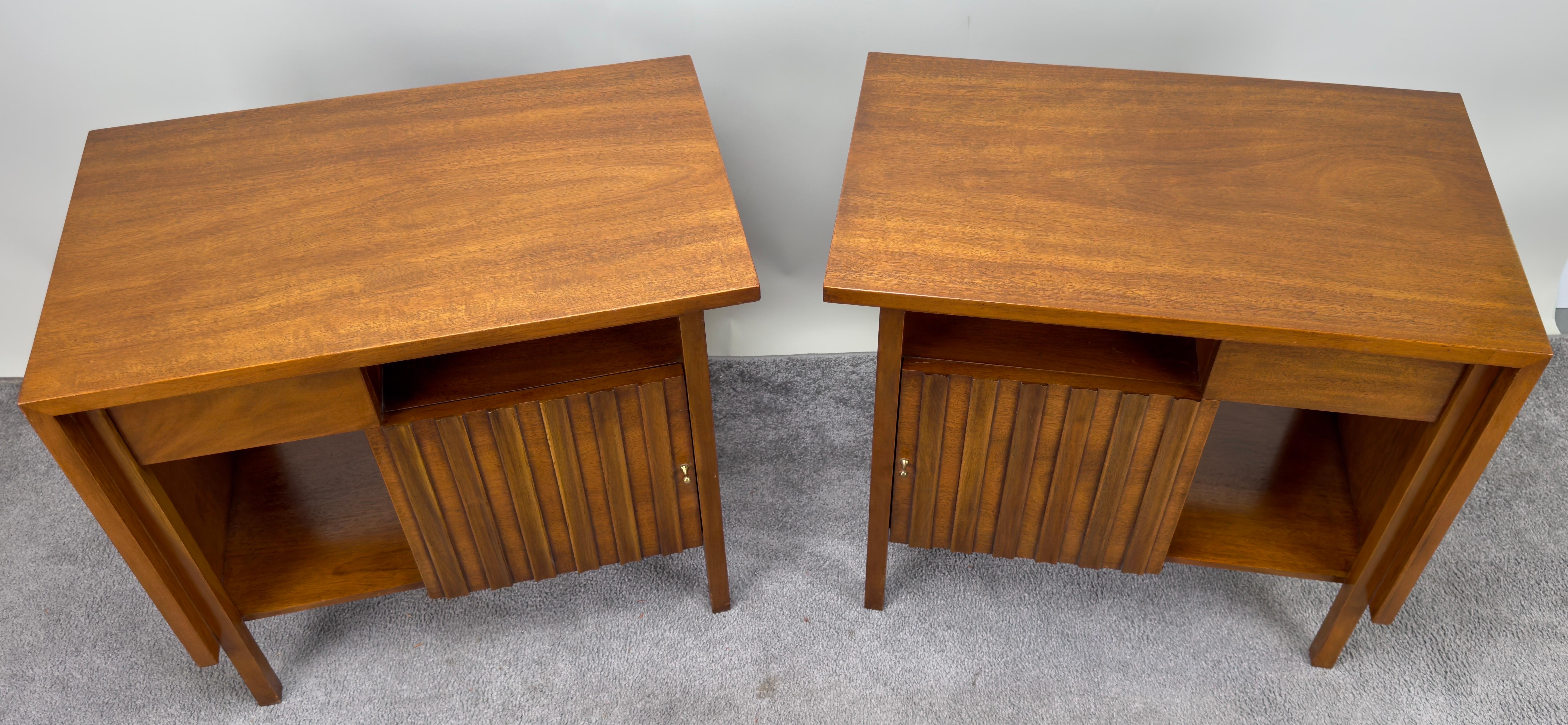 A pair of Mid Century Modern nightstands or end tables crafted with impeccable quality by the renowned John Widdicomb. These solid nightstands showcase a harmonious blend of form and function. Each nightstand boasts a thoughtfully designed