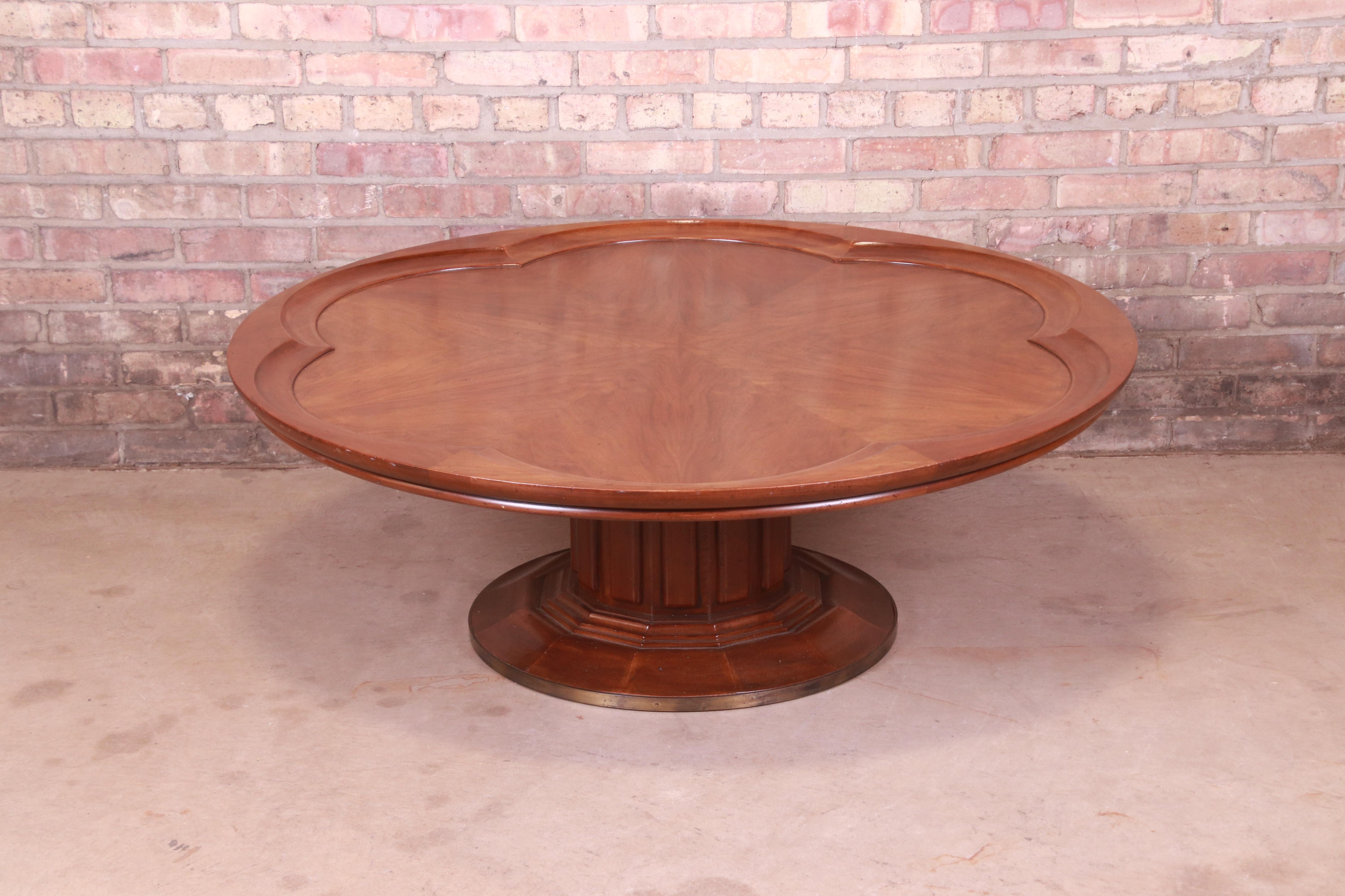 A gorgeous Mid-Century Modern round pedestal coffee or cocktail table

By John Widdicomb

USA, circa 1960s

Walnut with starburst inlay top, and carved solid walnut pedestal base with brass banding.

Measures: 48