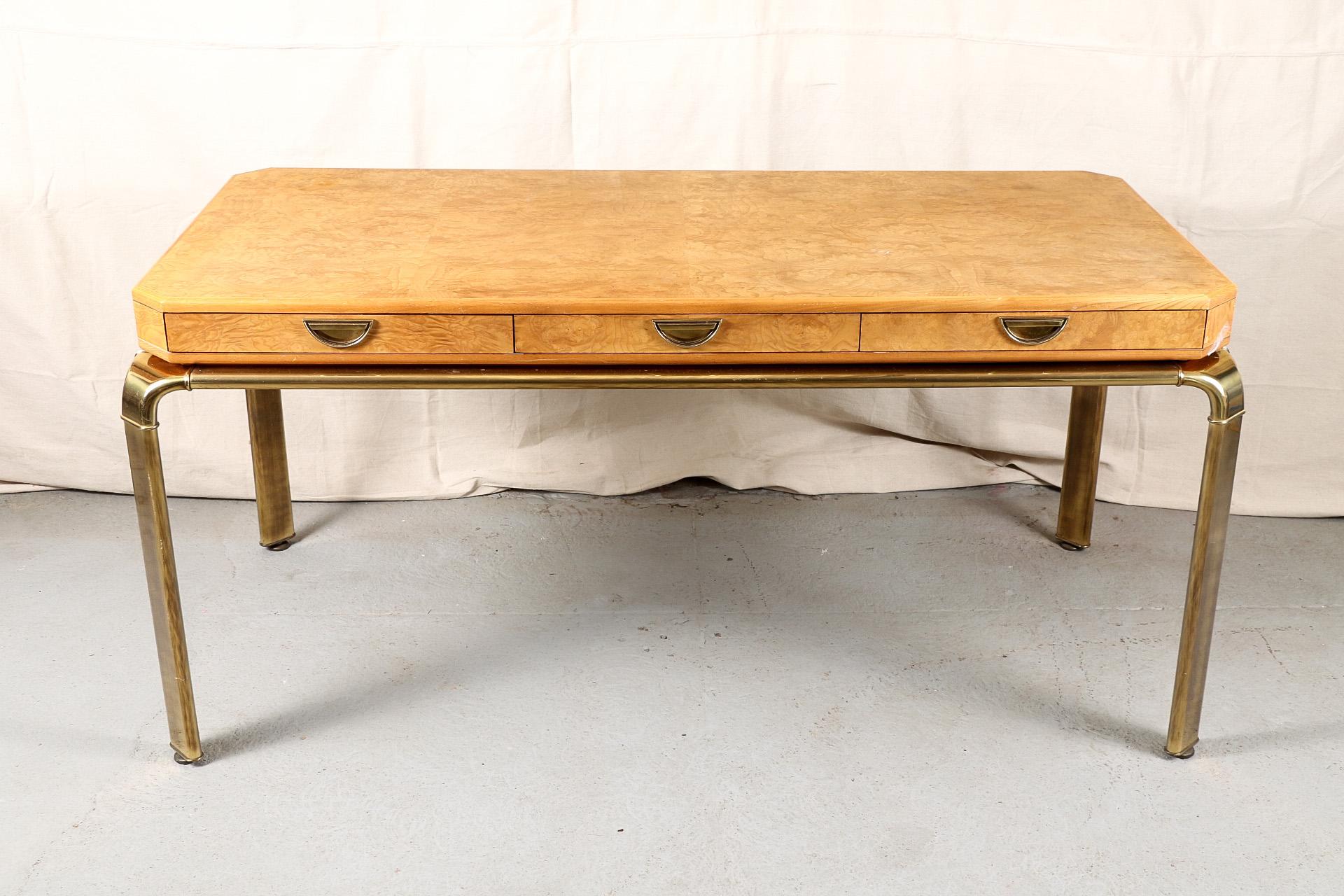 John Widdicomb modern desk, pale burled wood top with canted corners, three frieze drawers with brass pulls, mounted on a brass frame with flat canted curved legs. 

Condition: Some tarnish to brass accents otherwise good.