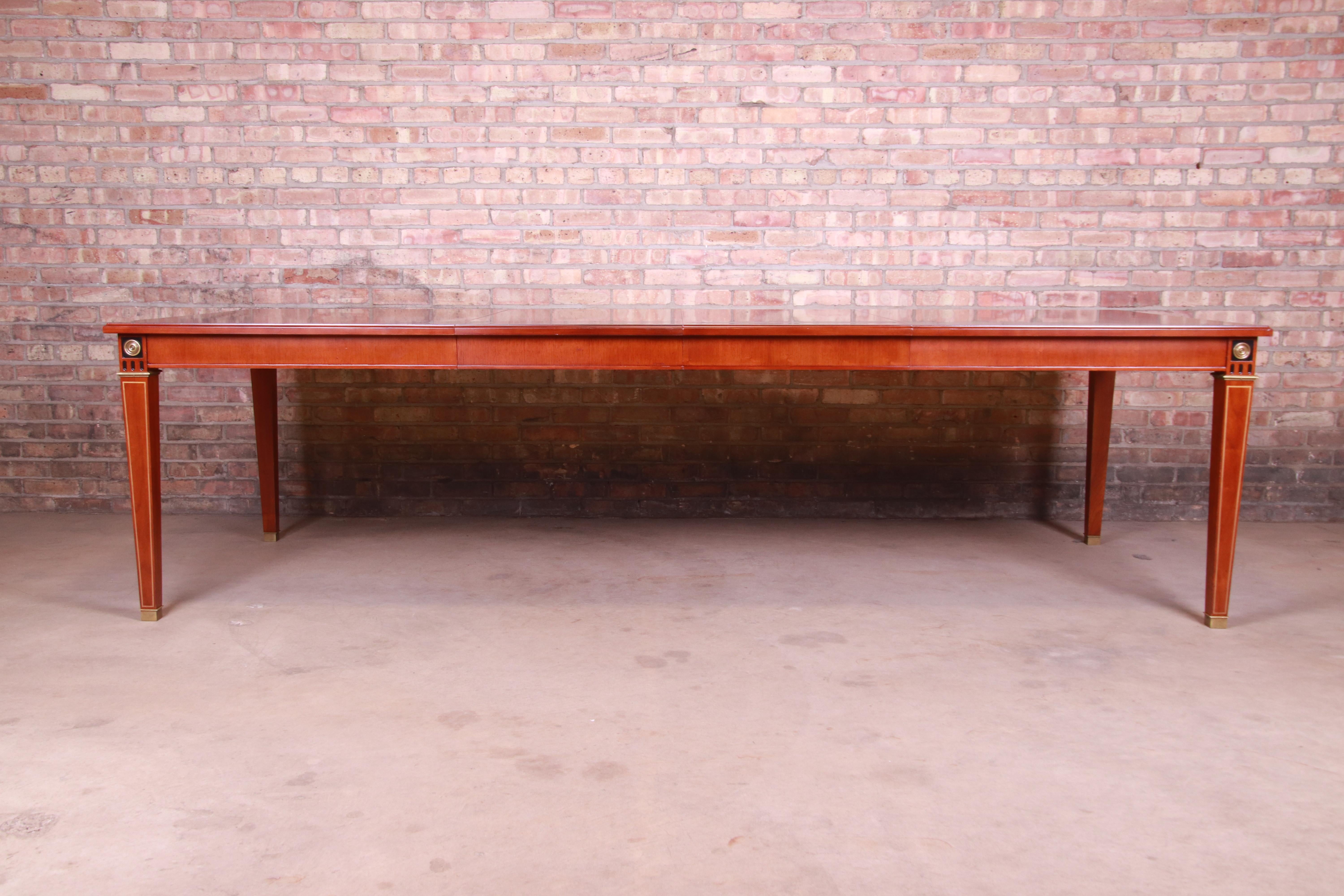 An exceptional neoclassical style extension dining table

By John Widdicomb

USA, late 20th century

Bookmatched mahogany, with ebonized wood and gold gilt details and brass sabots and accents.

Measures: 68