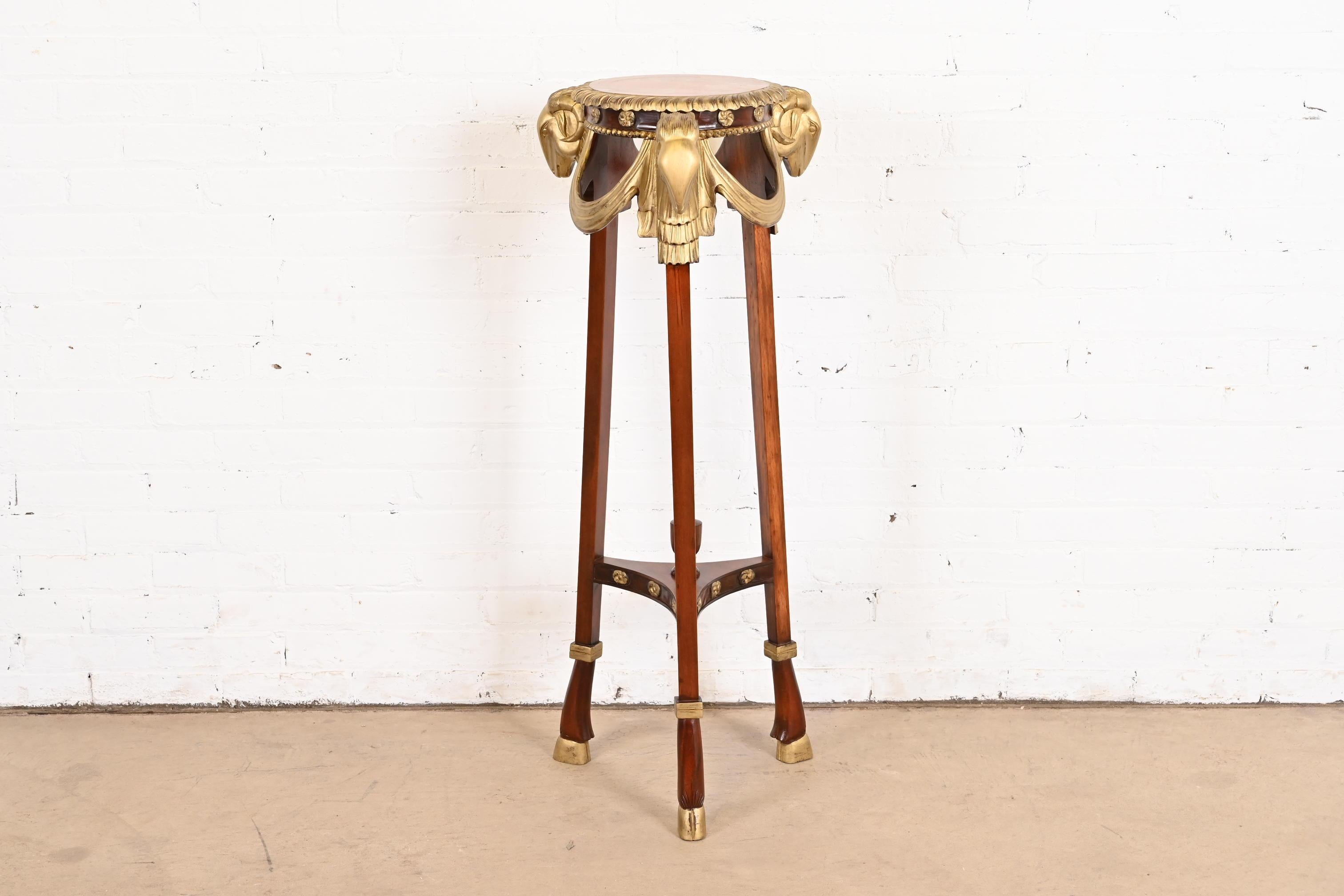 An exceptional ornate Regency or Neoclassical style guéridon, pedestal table, or plant stand

By John Widdicomb

USA, Circa 1980s

Gorgeous mahogany, with carved gilt wood swags and ram heads, and hooved feet.

Measures: 15