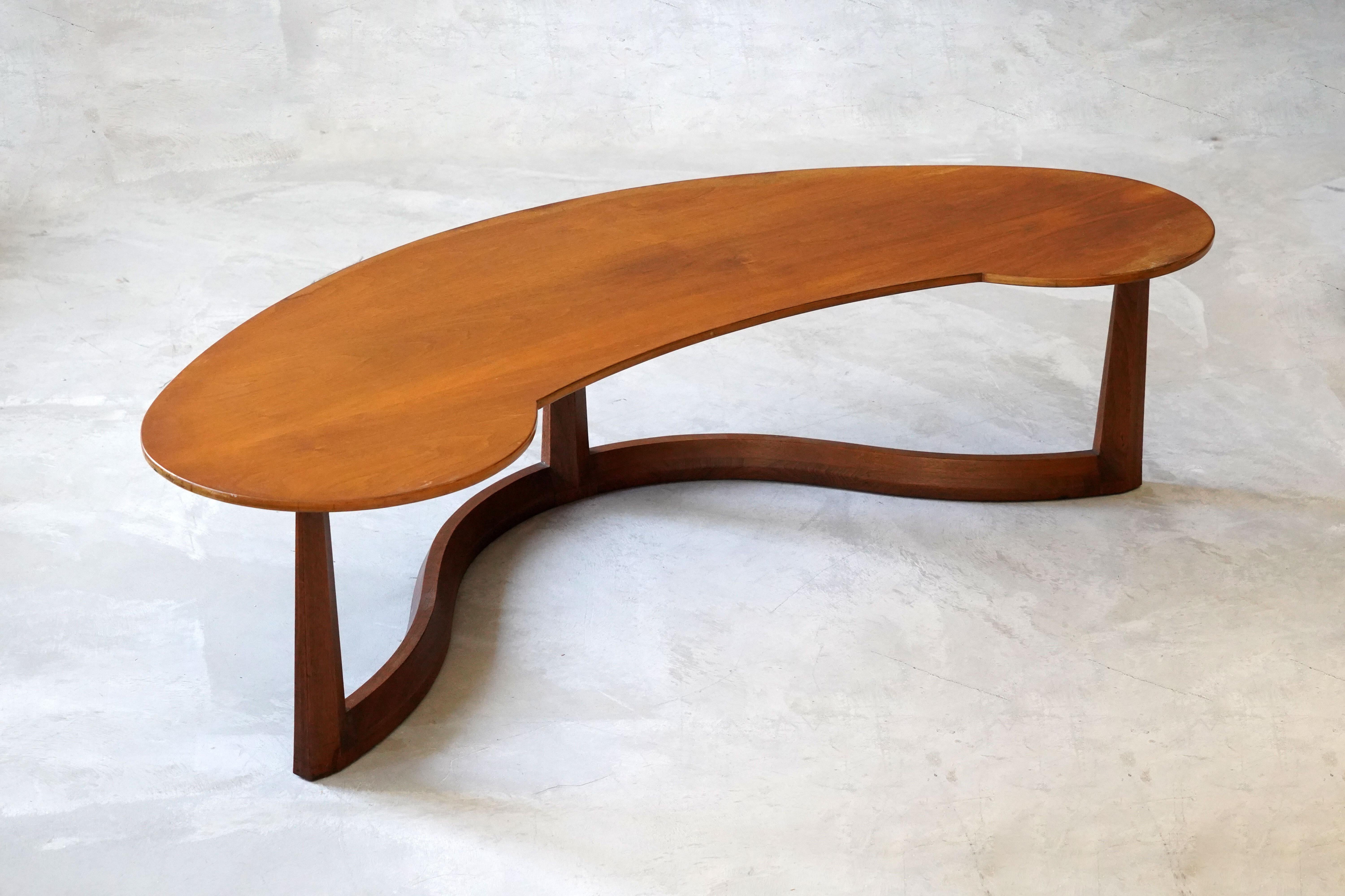 A rare sizable organic coffee or cocktail table. Designed and produced by John Widdicomb, Grand Rapids, Michigan, America. Produced in the 1950s. With makers label.

Other designers of the period include T.H. Robsjohn Gibbings, Paul Frankl, Tommi