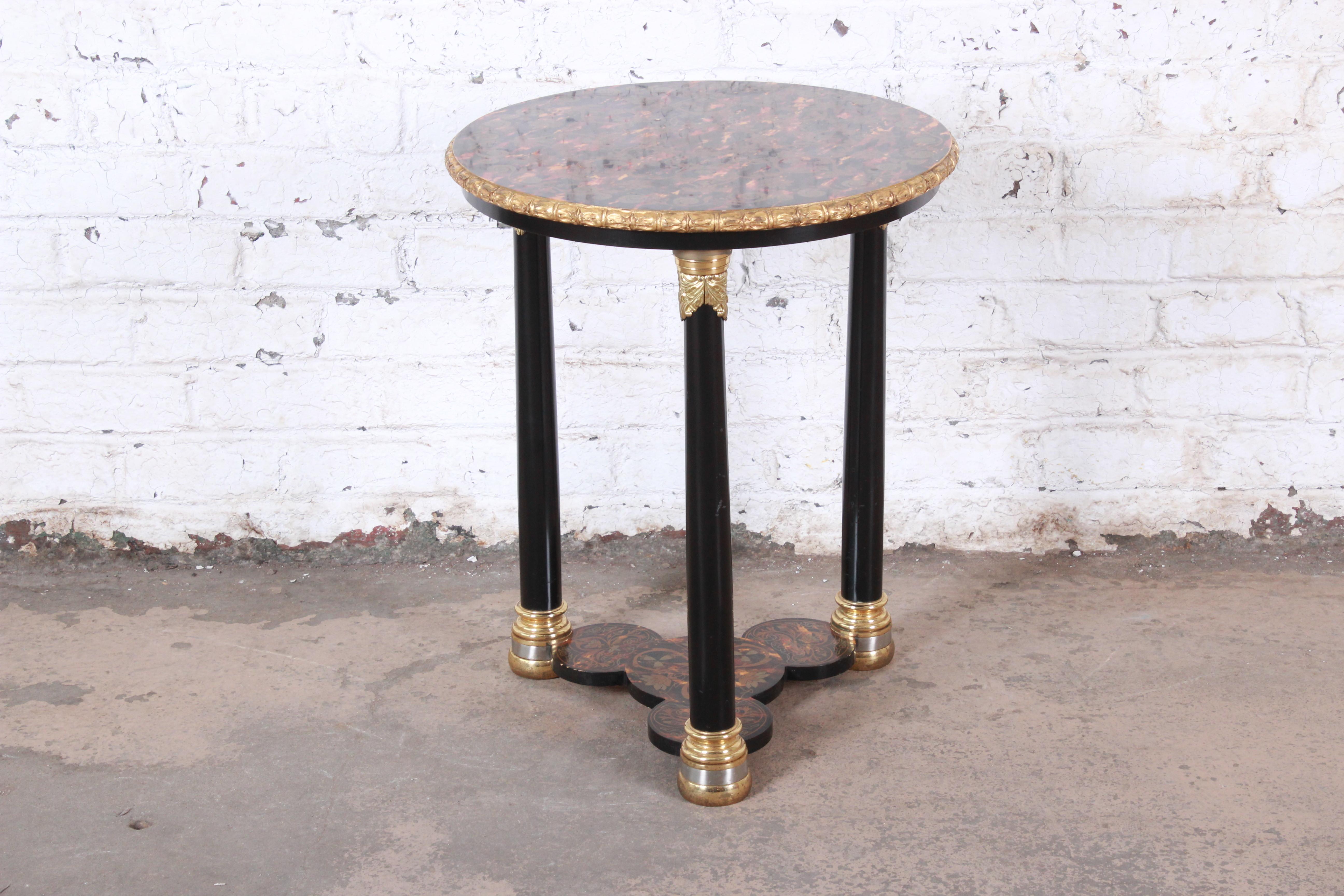 Ornate neoclassical style occasional side table

Made by John Widdicomb

USA, 2000s

Ebonized wood and brass and giltwood and paint

Measures: 23.25
