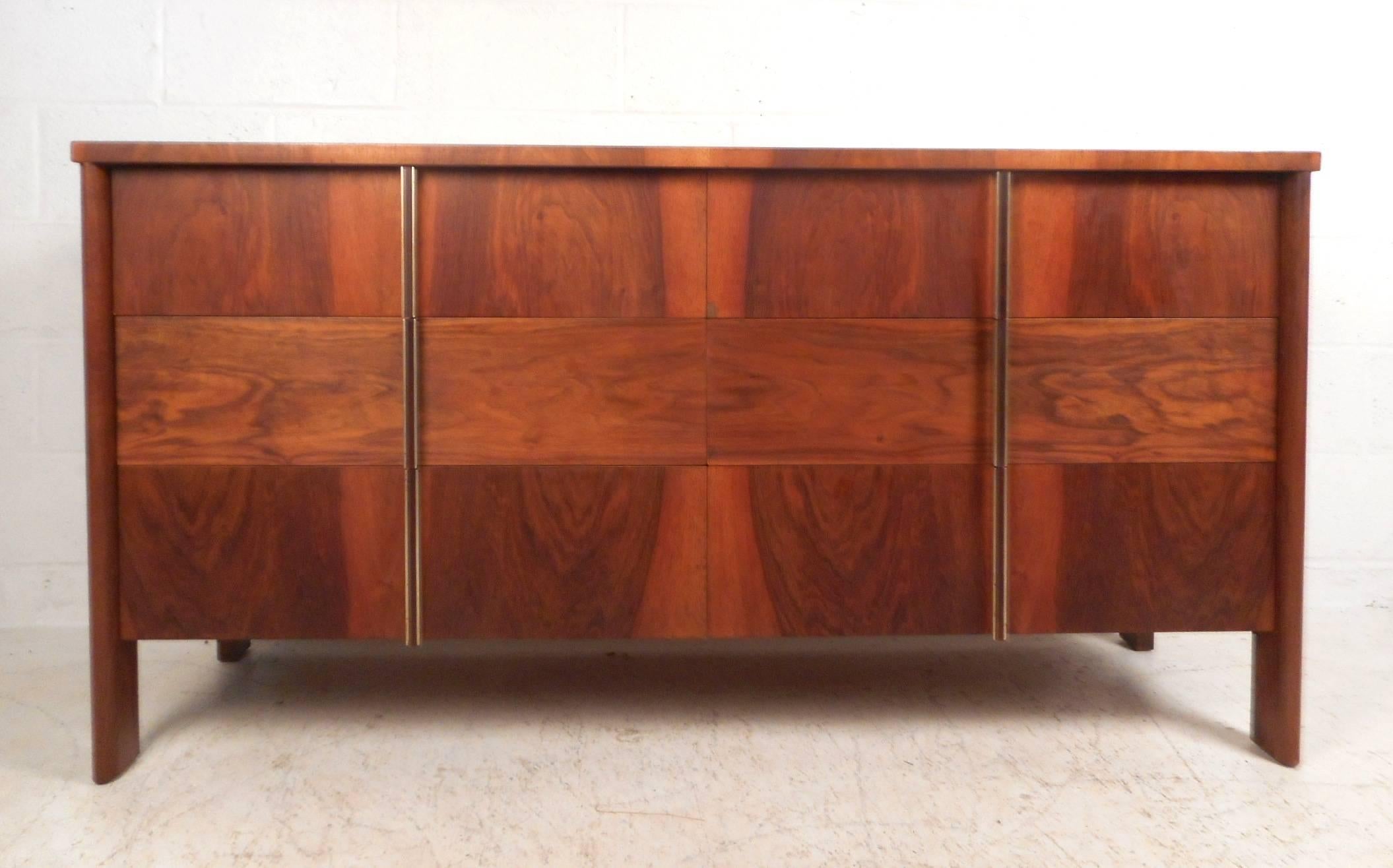 This stunning Mid-Century Modern dresser features six large drawers with aluminium brushed pulls. A compact design with wood grain running in different directions on the front. Unique rosewood drawer pulls encased in brushed aluminium and sturdy