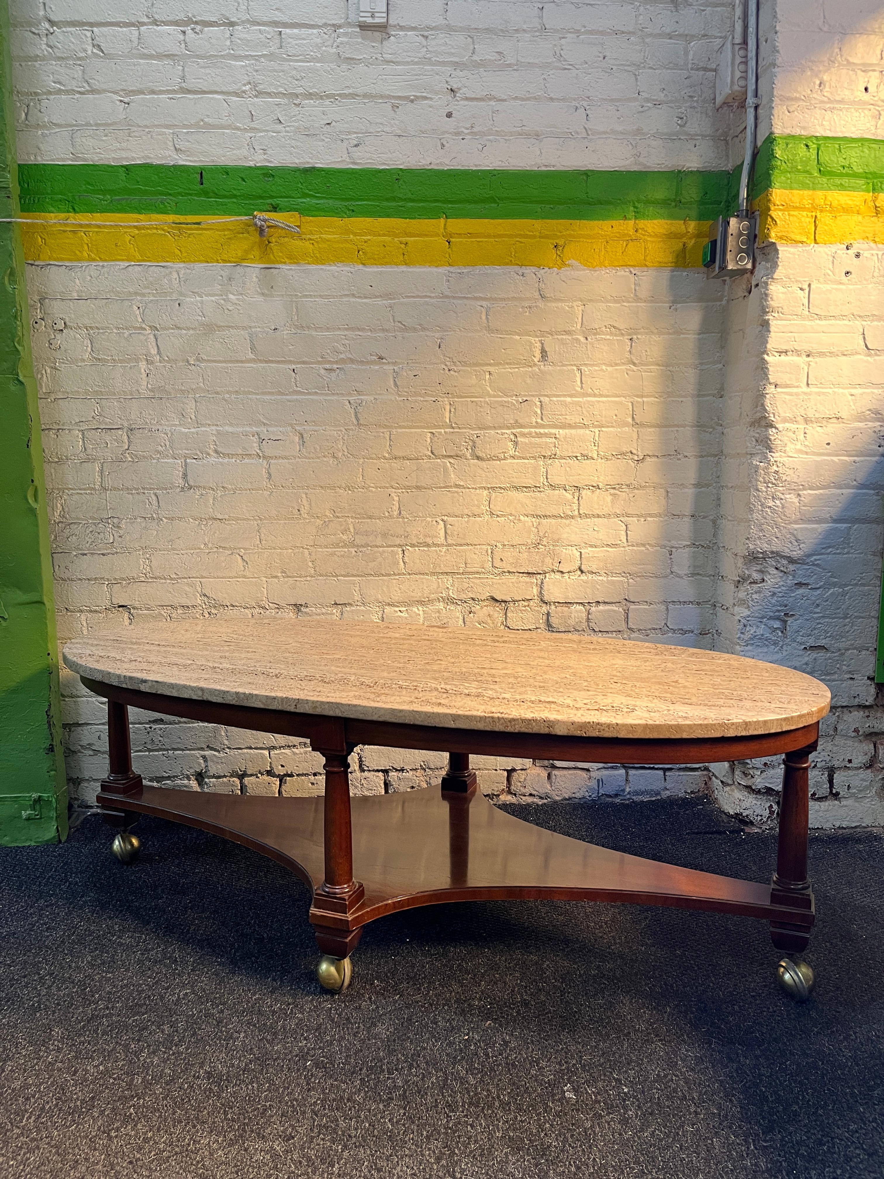 One beautiful surfboard style 2 tier coffee table by William a Berkey Furniture - John Widdicomb. Of walnut frame and travertine slate top on brass casters. 1960s.

