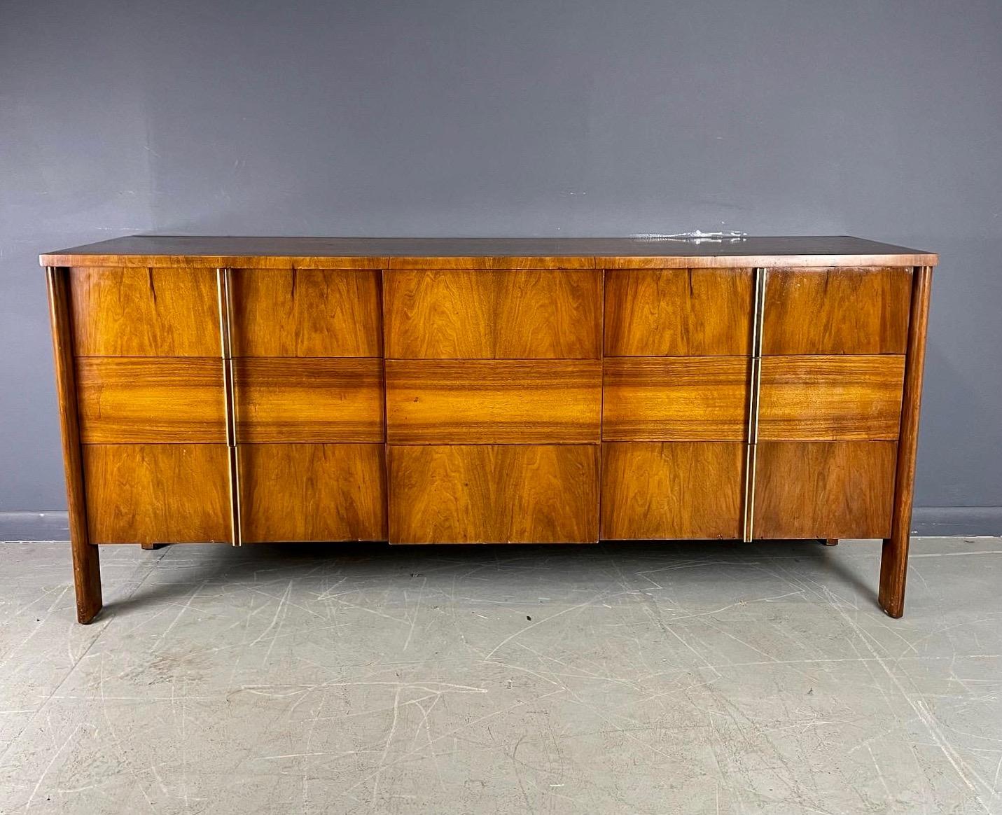 Exquisitely constructed with wonderfully grained walnut with rosewood inlaid handles, this is a masterpiece of furniture construction designed by Dale Ford for John Widdicomb.