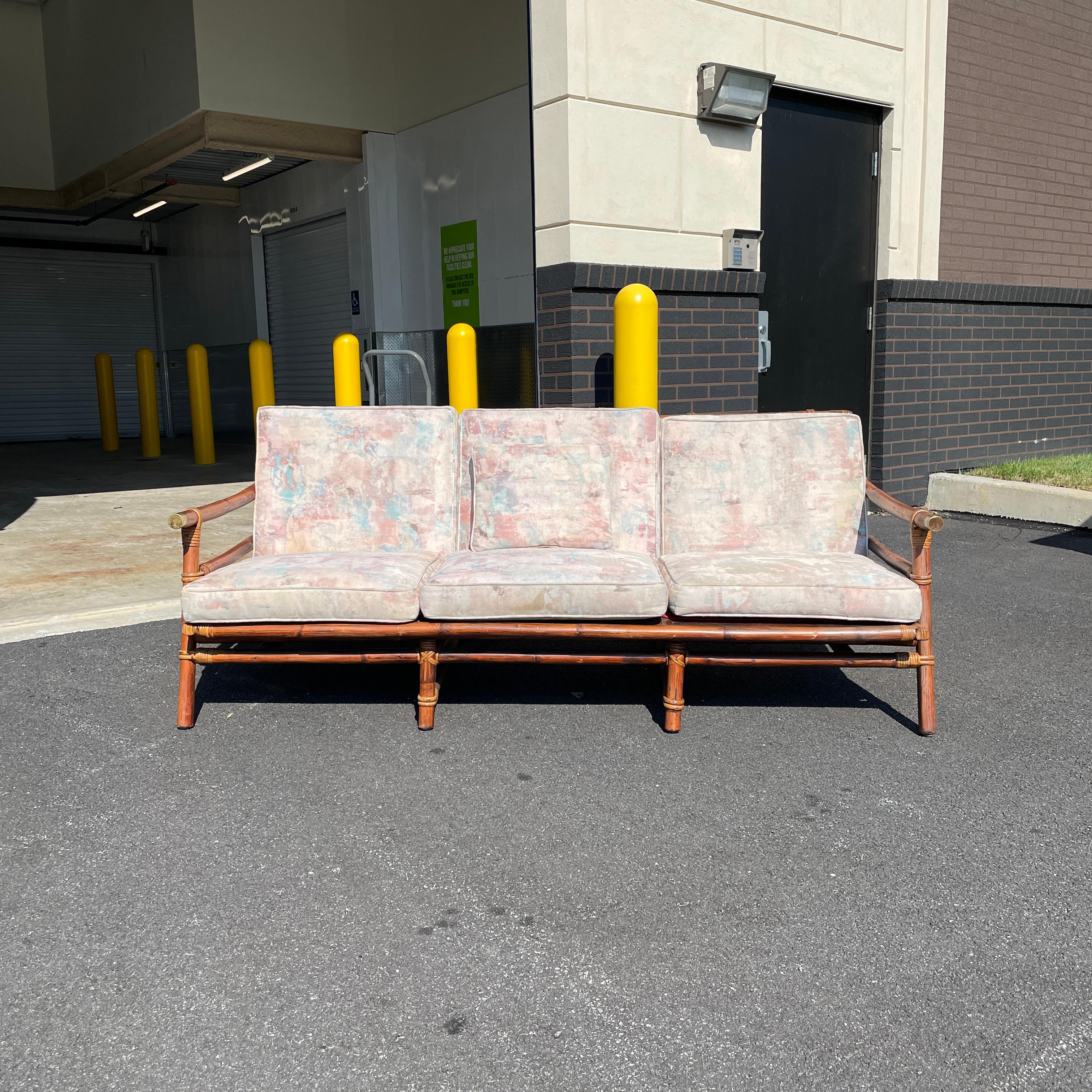 A Mid-Century Modern Far Horizons rattan sofa by John Wisner for Ficks Reed. The wood has been re-oiled, making it look like new. The cane backing of the seat is in good condition with only minor wear. The cushions are soft and clean. A great piece