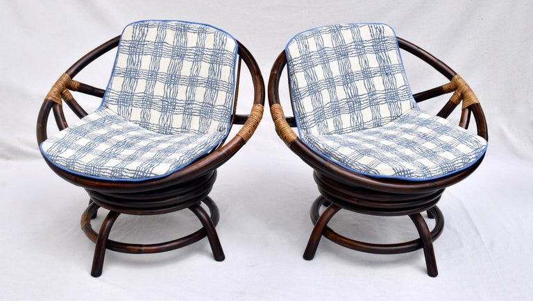 Scarcely Seen John Wisner Ficks Reed Far Horizons Line pair of Saucer Form Swivel Lounge Bamboo Rattan Chairs with New Custom Cushions Upholstered in New Vintage Stock Brunschwig & Fils Woven Cottton Linen, circa 1960s .Two pairs are available.