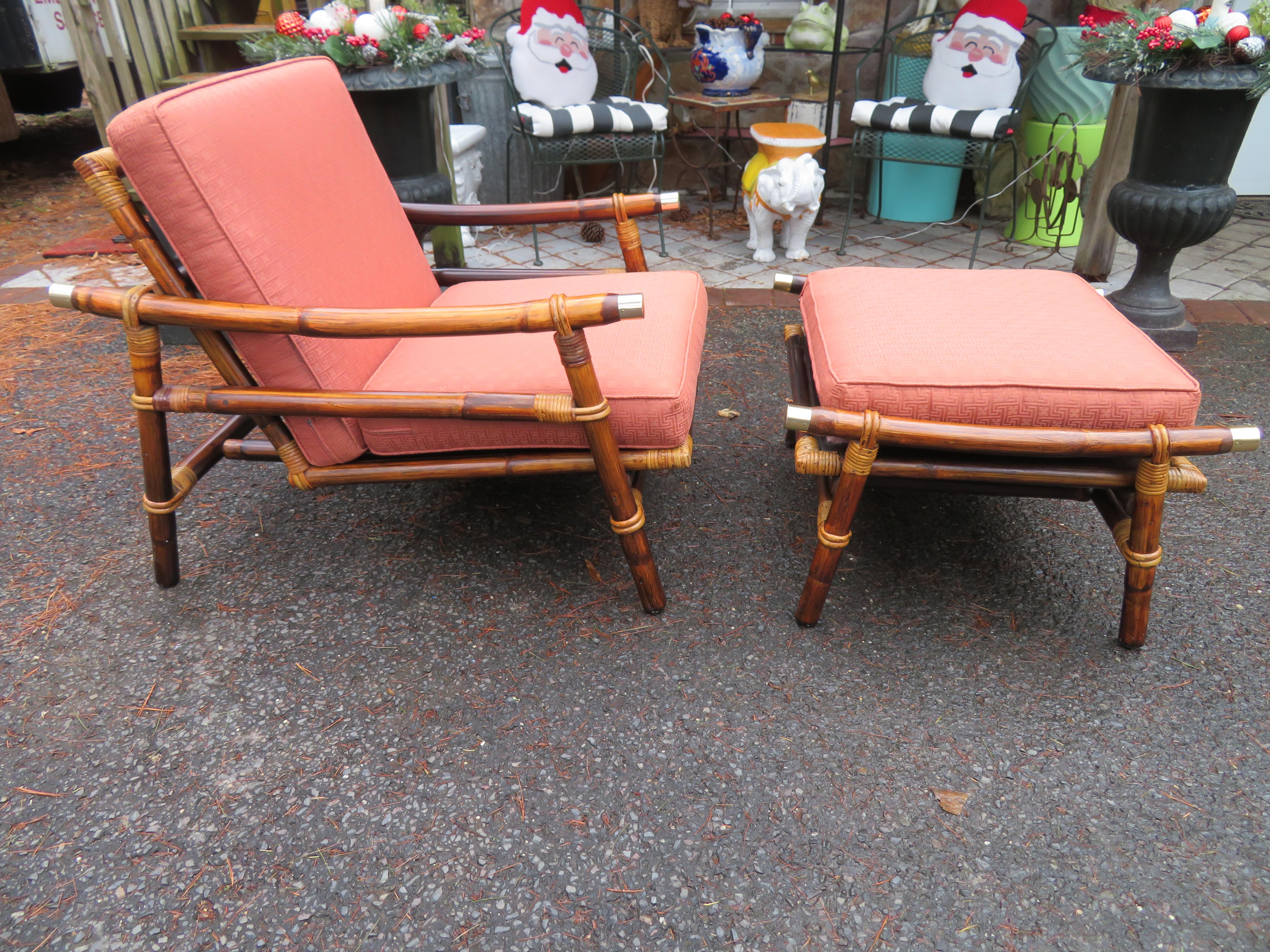 Ficks Reed rattan Campaign style lounge or club chair plus ottoman with interesting brass cap accents by John Wisner for the Far Horizons collection, 1954. This set retains its original finish in very nice vintage condition-one of the nicest we have