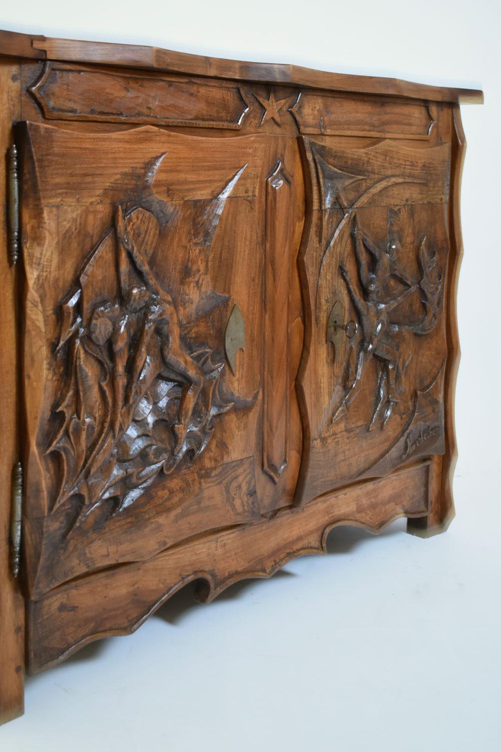 Oak brutalist sideboard, cabinet, chest of drawers opening with two doors and adorned with a rich carved decoration representing dancers by Johnny Ludécher France, 1950s.