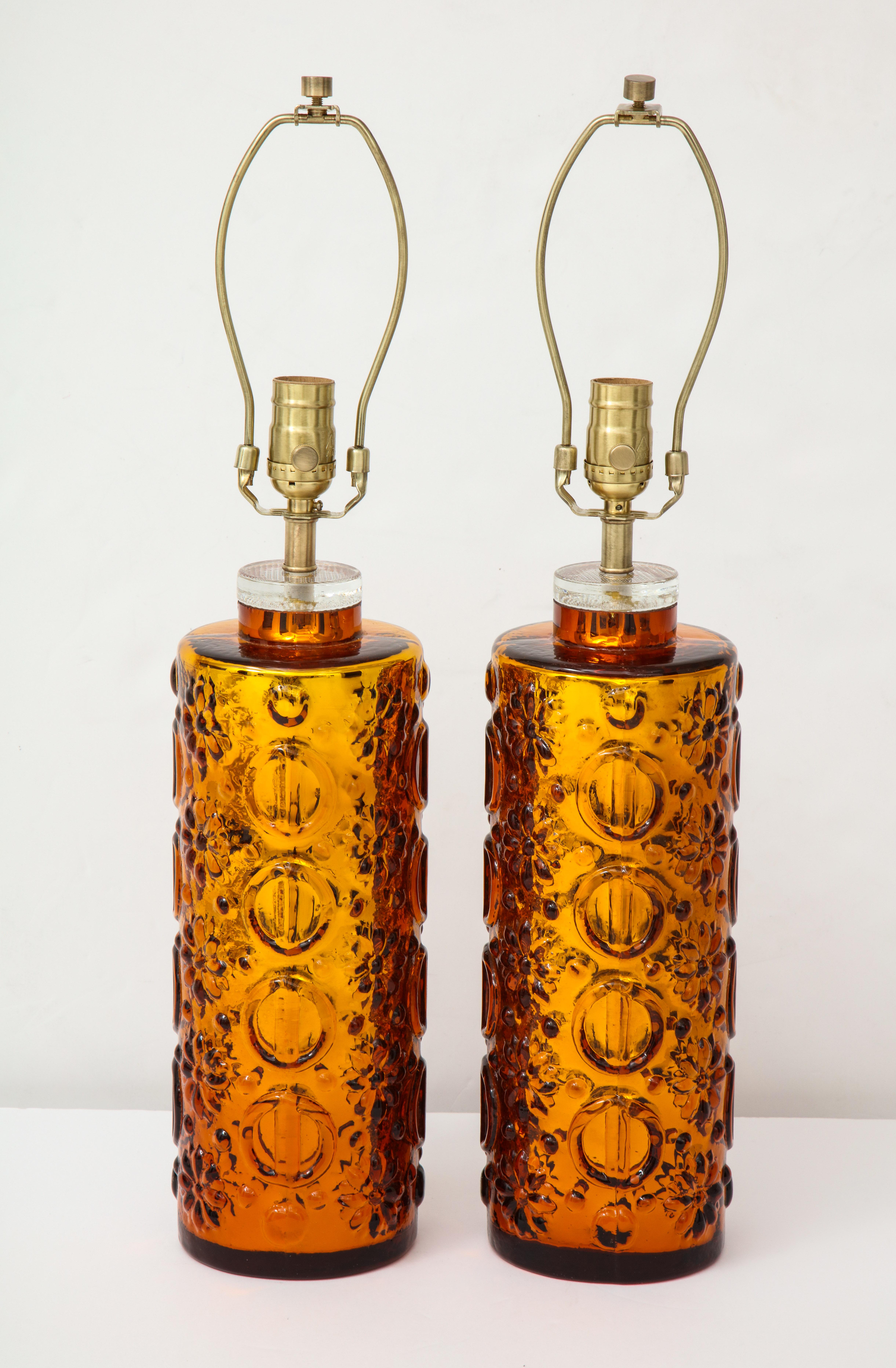 Pair of Scandinavian Modern heavy molded glass lamps with a gold mercury glass interior finish, and graphic patterned clear glass overlay. Rewired for use in the USA. 100W max bulbs.