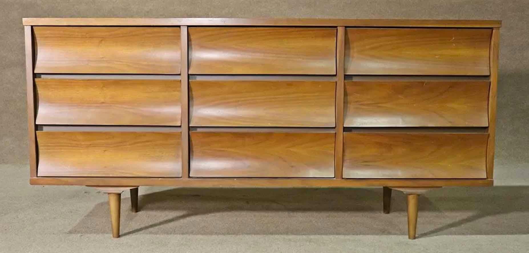 Long mid-century dresser by Johnson Carper for their Brentwood series. Attractive curved drawers and walnut grain. Mirror is not attached and measures 45