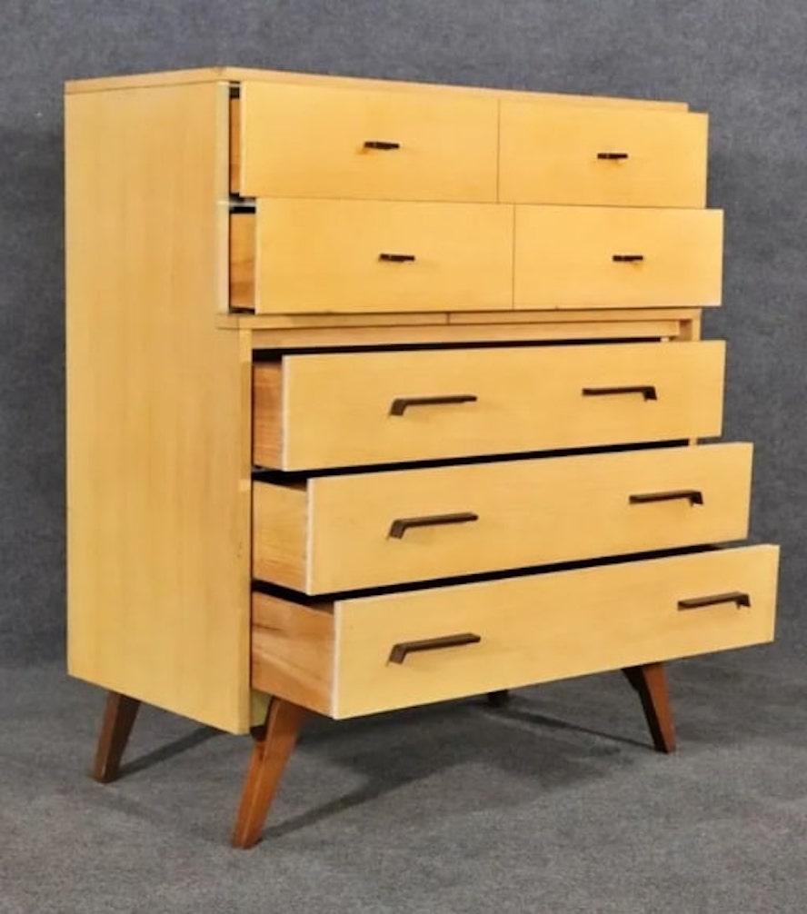 Mid-century modern tall chest of drawers by Johnson Carper. Made famous on the set of I Love Lucy. Five wide drawers with contrasting wood and carved handles.
Please confirm location NY or NJ