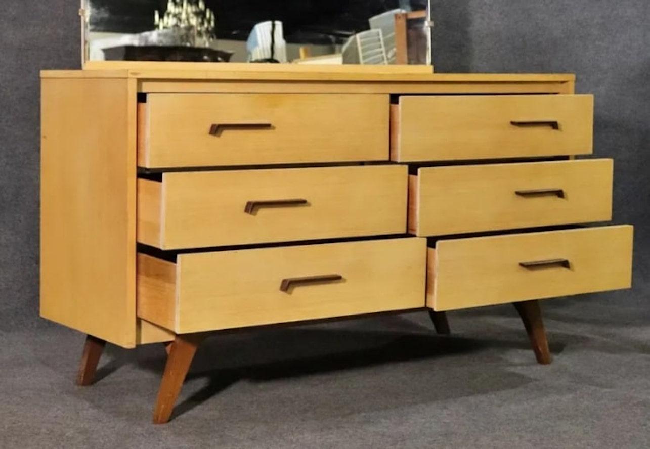 Mid-century modern dresser by Johnson Carper with mirror. Made famous as the bedroom set of I Love Lucy, this dresser features contrasting wood, bent handles and large mirror.
Please confirm location NY or NJ