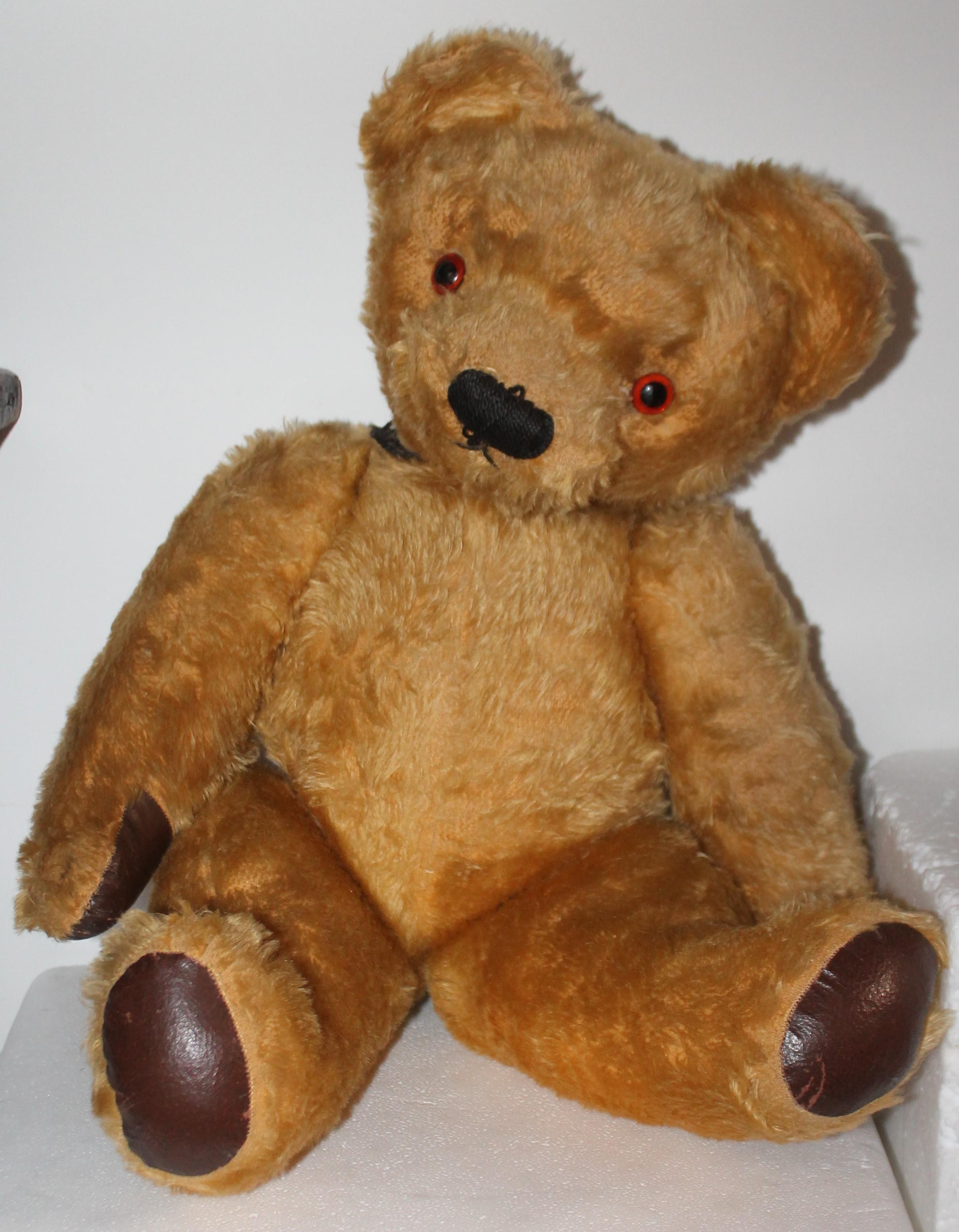 20th century mohair hump back jointed bear with a wind up inside the bear. The pats are leather and in very good condition.