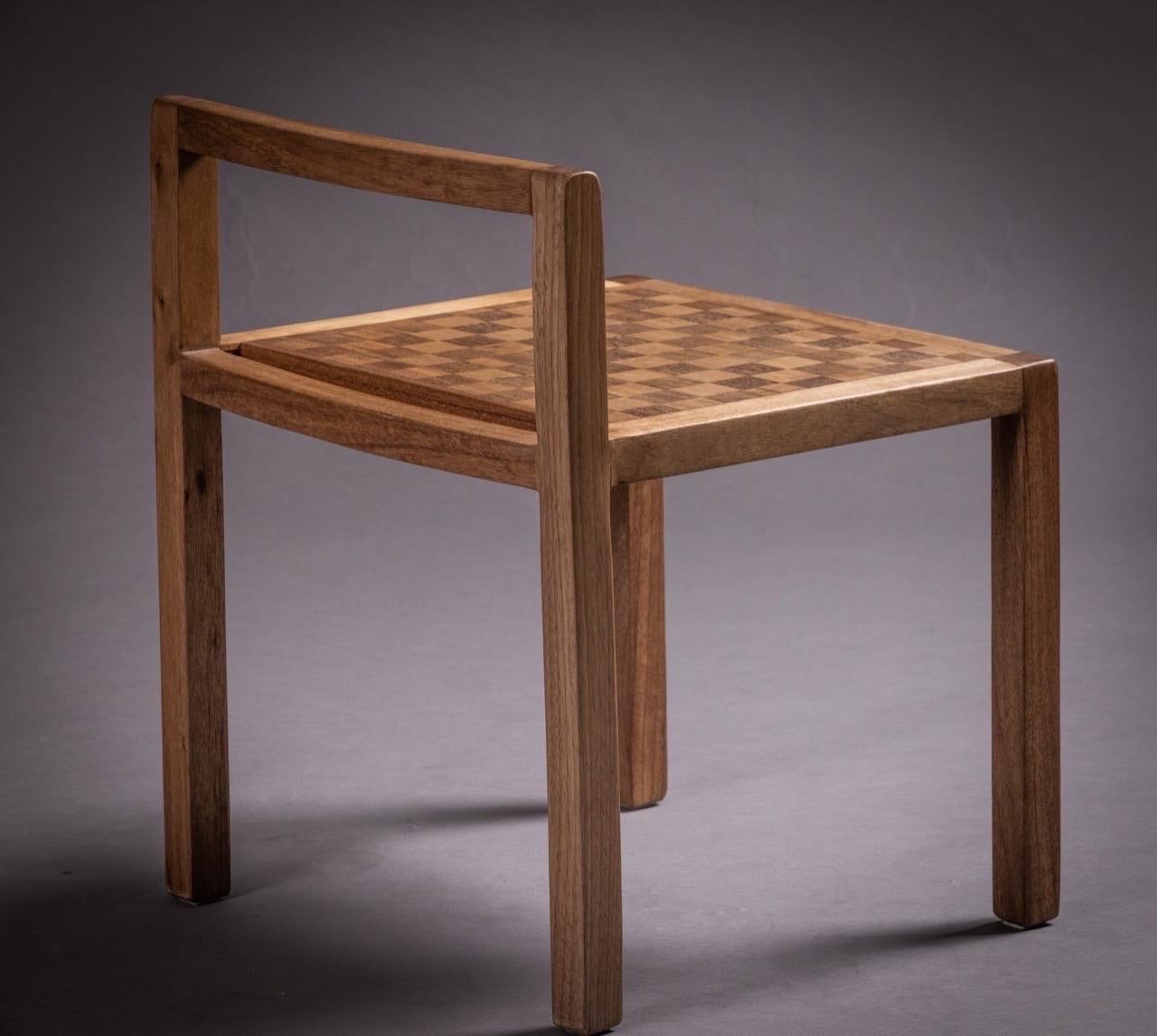 The charming Jojo stool features a checkered marquetry seat, skillfully crafted with the fine woods Jequitibá and Sucupira. Its sturdy structure is also made of high-quality Jequitibá, providing durability and elegance. Beyond its decorative