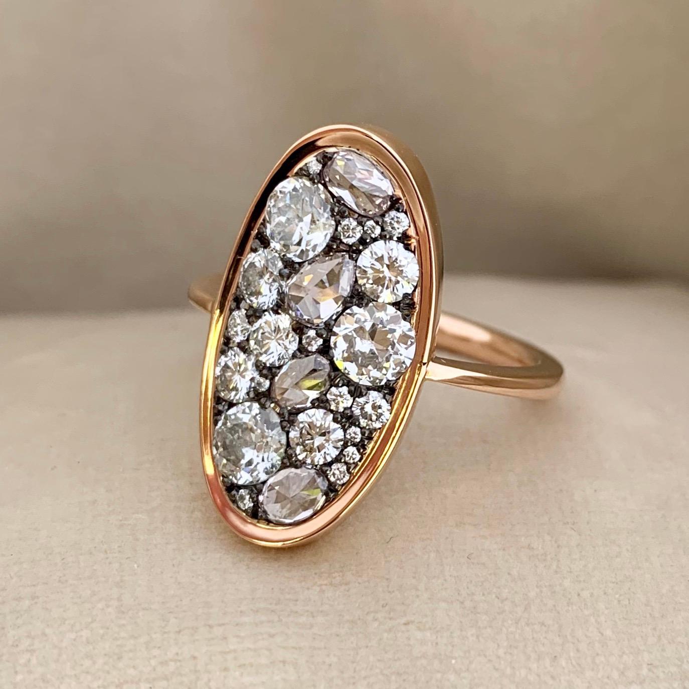 One of a kind ring in 18K Rose gold 5 g & blackened sterling silver (The stones are set on silver to create a black background for the stones)
Set with 3 white old-cut diamonds 0,75 ct., 4 light pink rose-cut diamonds 0,79 ct., white DEGVVS