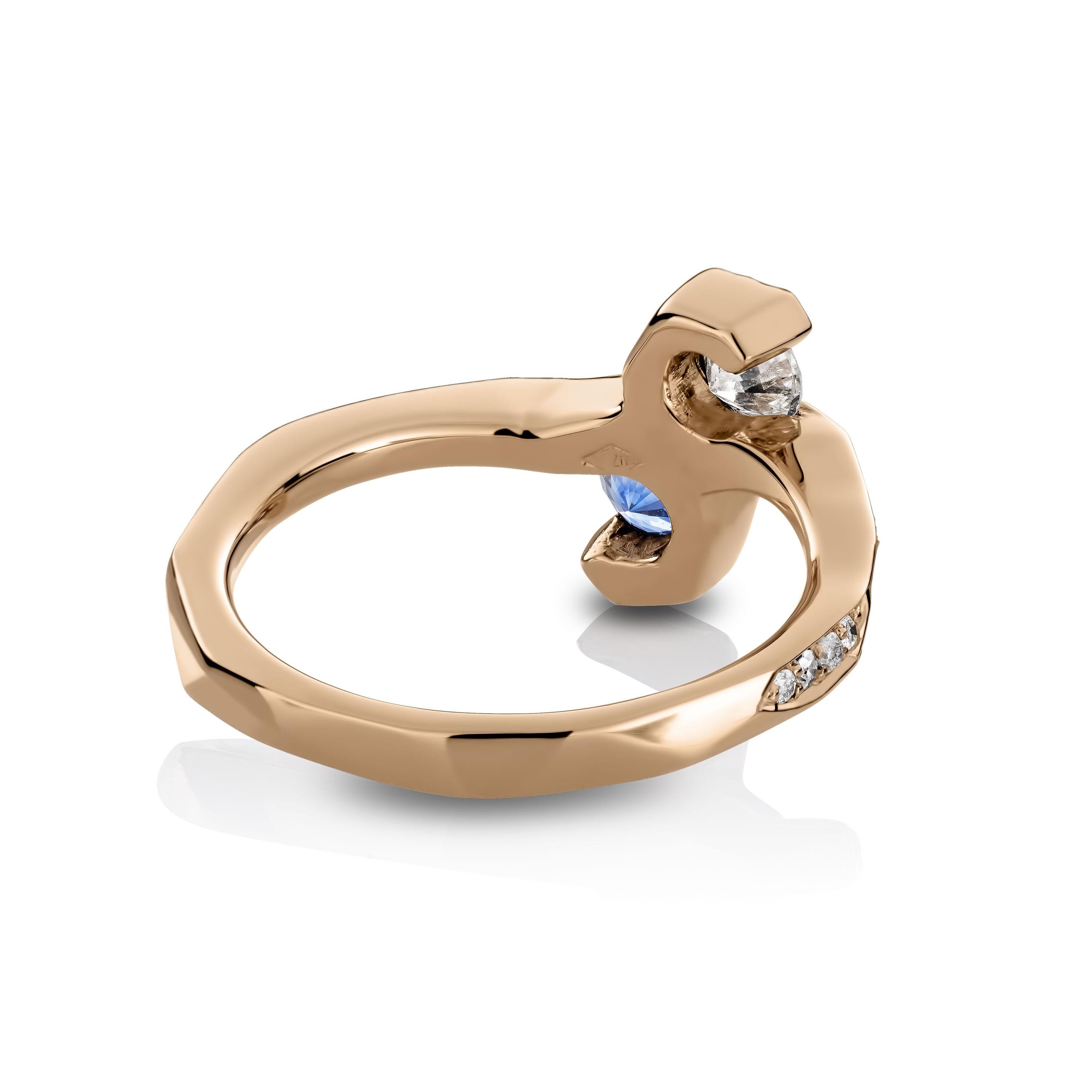 One of a kind ring in 18K Rose gold 4,6 g set with a brilliant-cut Sapphire 0,35 ct., white brilliant-cut diamond 0,23 ct., pave set sapphires 0,062 ct; pave set icy white , white and natural coloured blue diamonds 0,25 ct. One side of the ring is