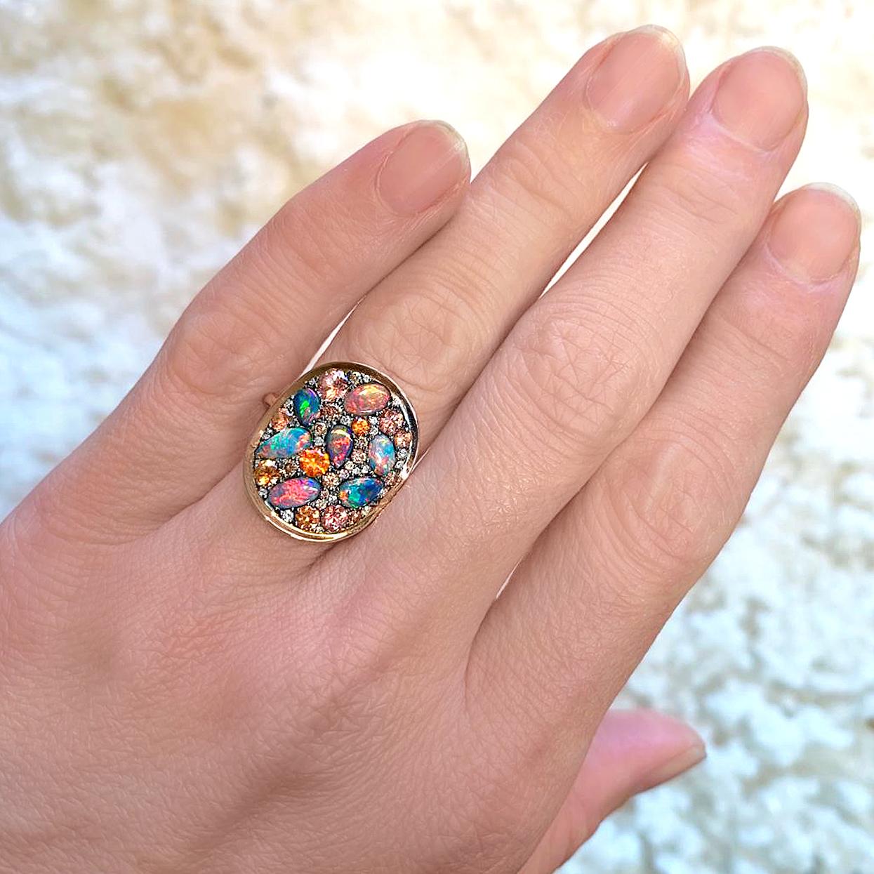 One of a Kind Starstruck Ring handcrafted in Belgium by jewelry maker Joke Quick in high-polished 18k rose gold featuring a curved oval element in blackened sterling silver set with an assortment of spectacular natural gemstones, including