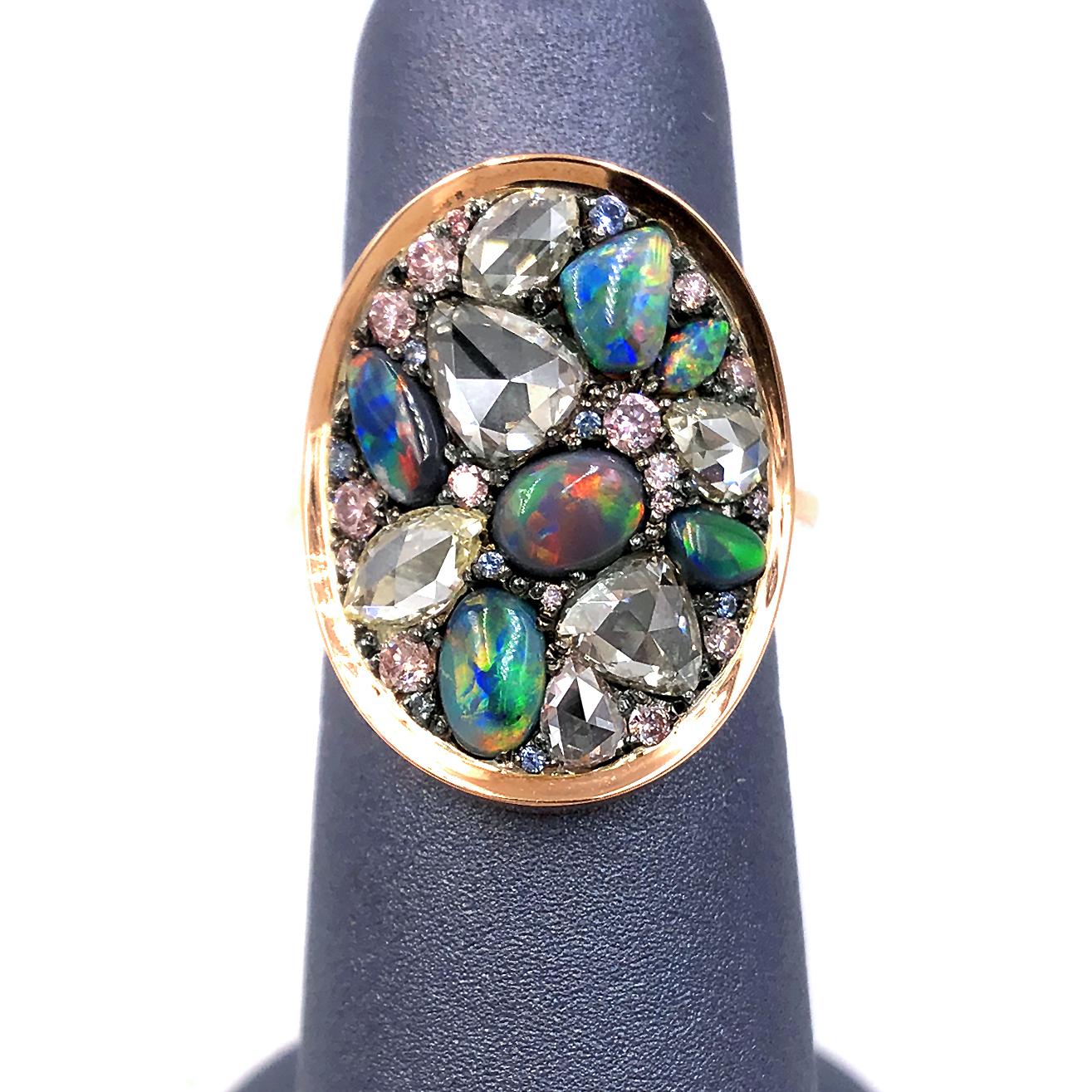 One of a Kind Starstruck Ring handcrafted in Belgium by jewelry maker Joke Quick in high-polished 18k rose gold featuring a curved oval element in blackened sterling silver set with an assortment of spectacular natural gemstones, including
