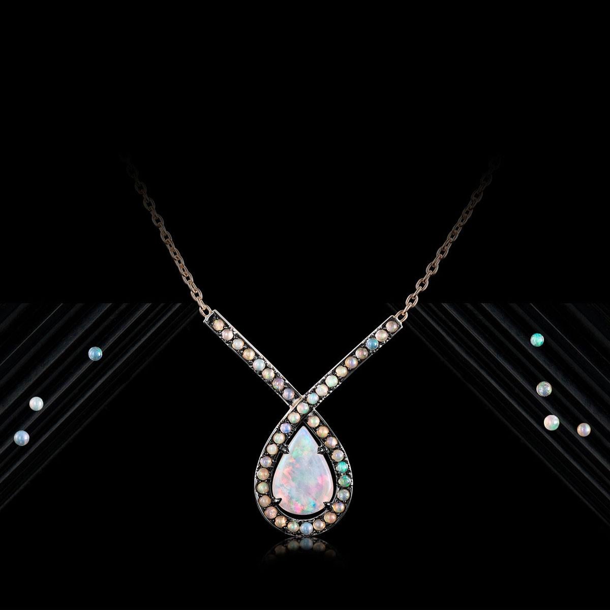 Pendant with Neclace in 18K Rose gold 7,8g set with a Pear shaped Australian Opal centerstone;  Castle & Pave set Athiopian Opal cabochons, The stonesetting is black rodium plated. Handmade the traditional way. Dimensions: Centerstone with