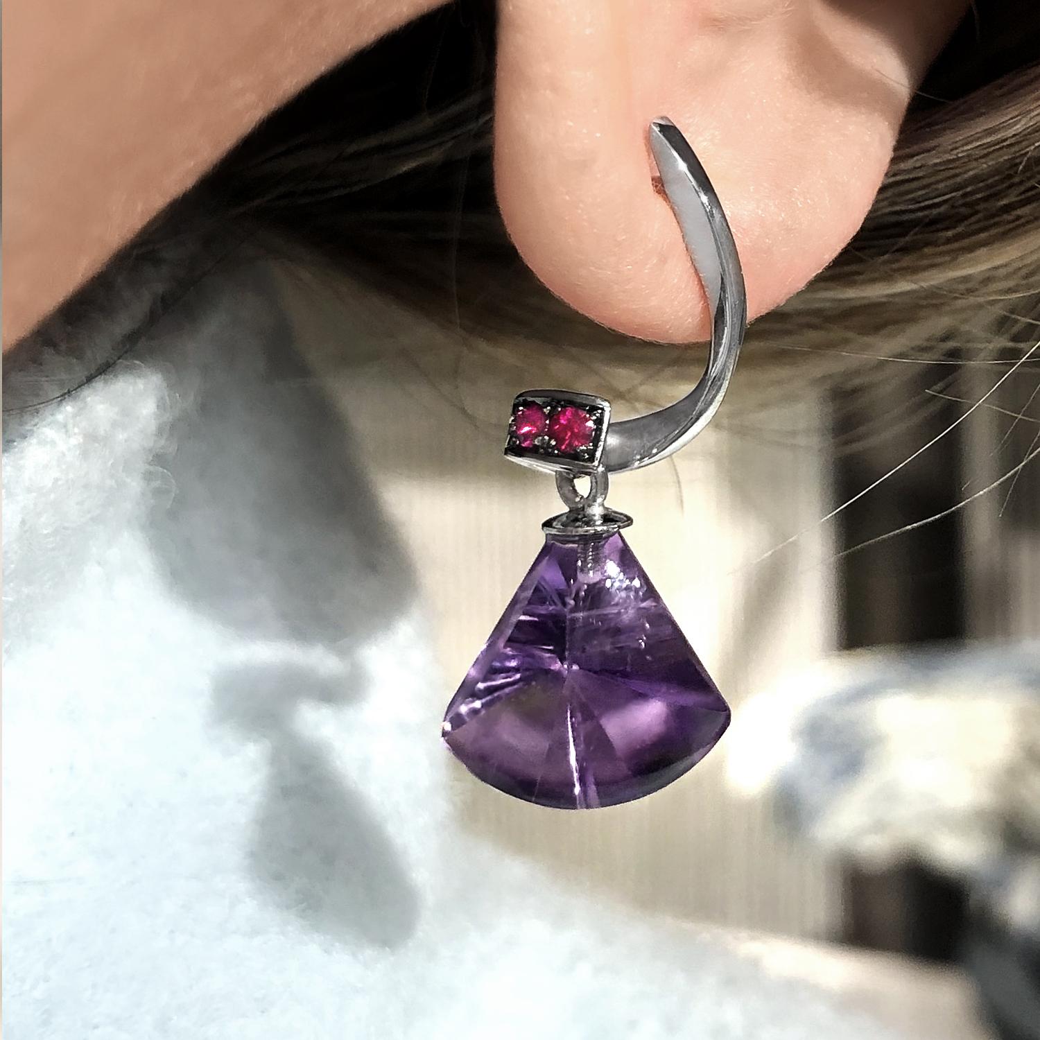 Spiral Drop Earrings handmade in Belgium by jewelry artist Joke Quick in 18k white gold featuring 9.07 total carats of custom-cut amethyst accented by four rubies totaling 0.13 carats. 

About the Maker - Joke Quick developed a fascination for fine