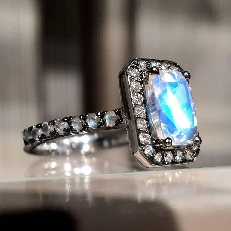 One of a Kind Twilight Entourage Ring handmade in Belgium by jewelry artist Joke Quick in 18k white gold showcasing a spectacular 1.22 carat faceted rainbow moonstone, surrounded by 0.22 carats of superior-quality DEF/vvs round brilliant-cut white