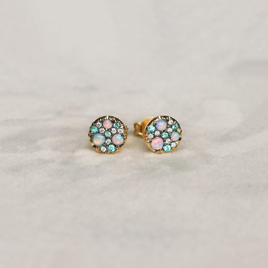 Handmade in Belgium, by jewellery designer Joke Quick, with no casting or printing involved, these yellow gold stud earrings display mesmerizing Paraiba Tourmaline's, Australian Opals and white diamonds, meticulously set in a pave design. Each stone