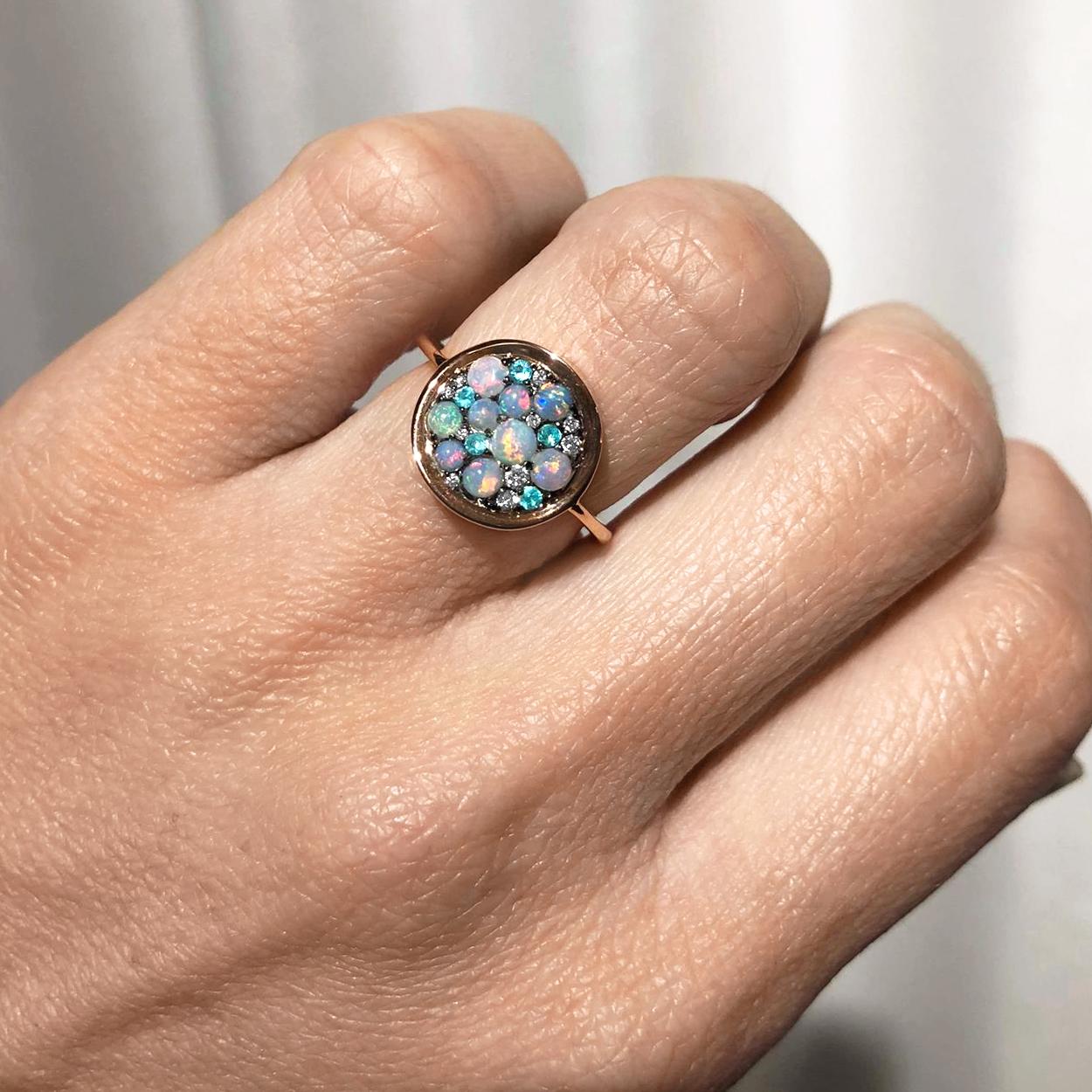 One of a Kind Starstruck Ring handmade in Belgium by jewelry artist Joke Quick in high-polished 18k rose gold featuring a curved oxidized sterling silver disc set with an assortment of spectacular Australian opal cabochons, Paraiba tourmaline