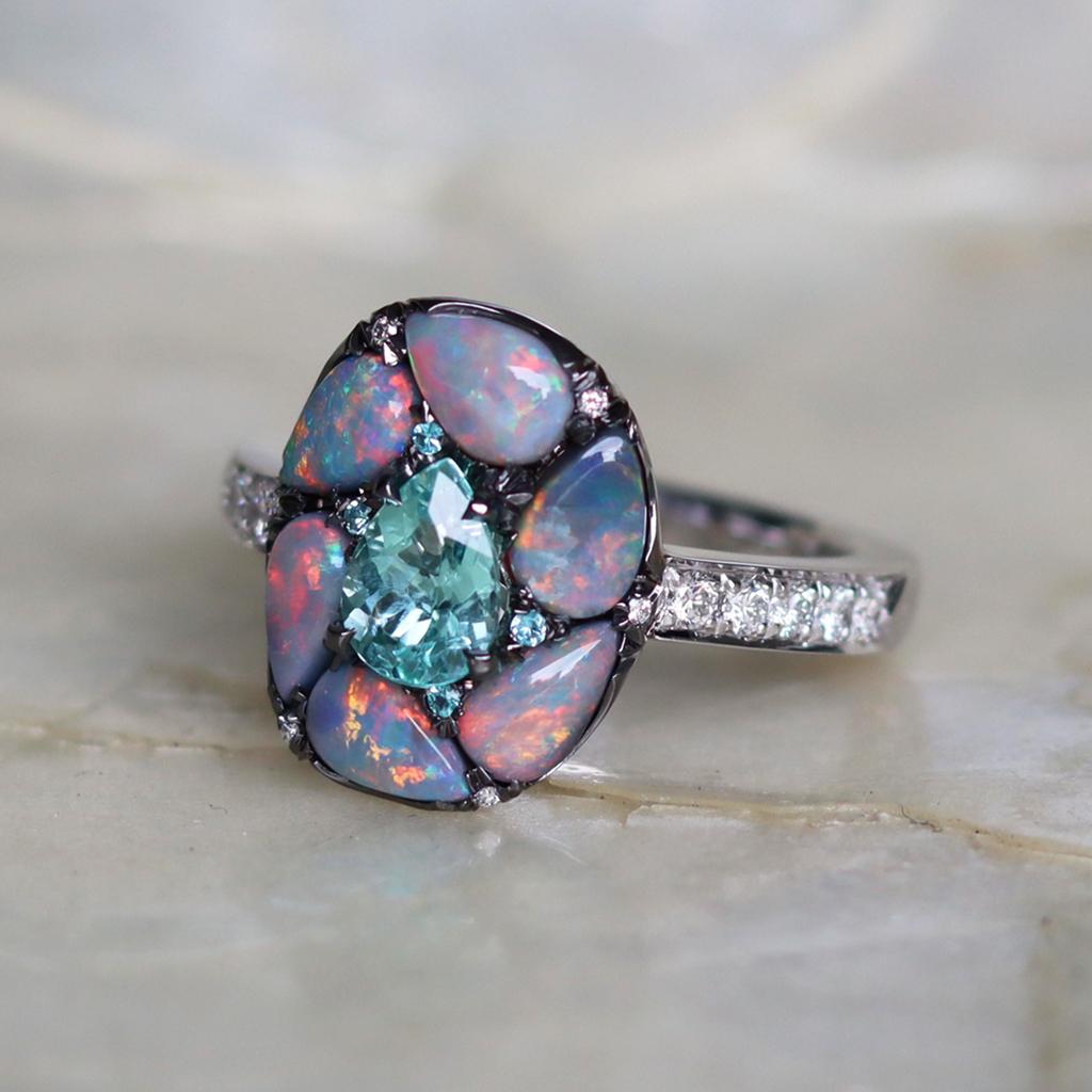 One of a kind Ring handmade in Belgium by jewellery designer Joke Quick, and handmade the traditional way, no casting or printing envolved. Ring in 18K White Gold 8.5 g.  Set with a 0.68 ct. Deep Greenish Blue Pear-Cut Paraïba Tourmaline centerstone