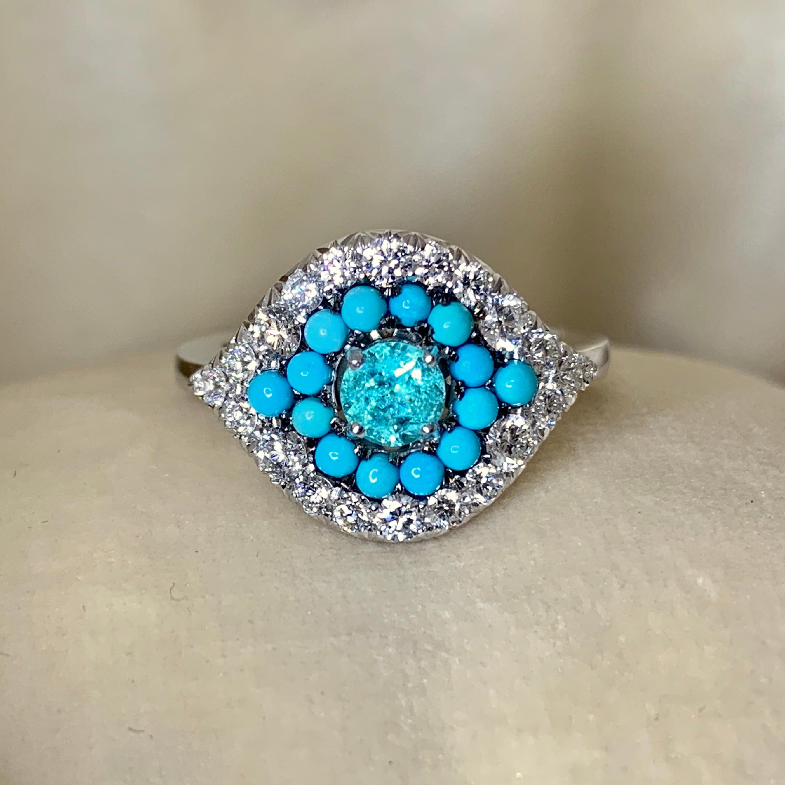 One of a kind ring handmade in Belgium from jewellery designer Joke Quick, in 18K White gold 9,7 g. Set with a Paraiba Tourmaline centerstone 0,39 Carat., Turquoise cabochons, White brilliant-cut diamonds DEGVVS 0,71 ct.;  Handmade the traditional