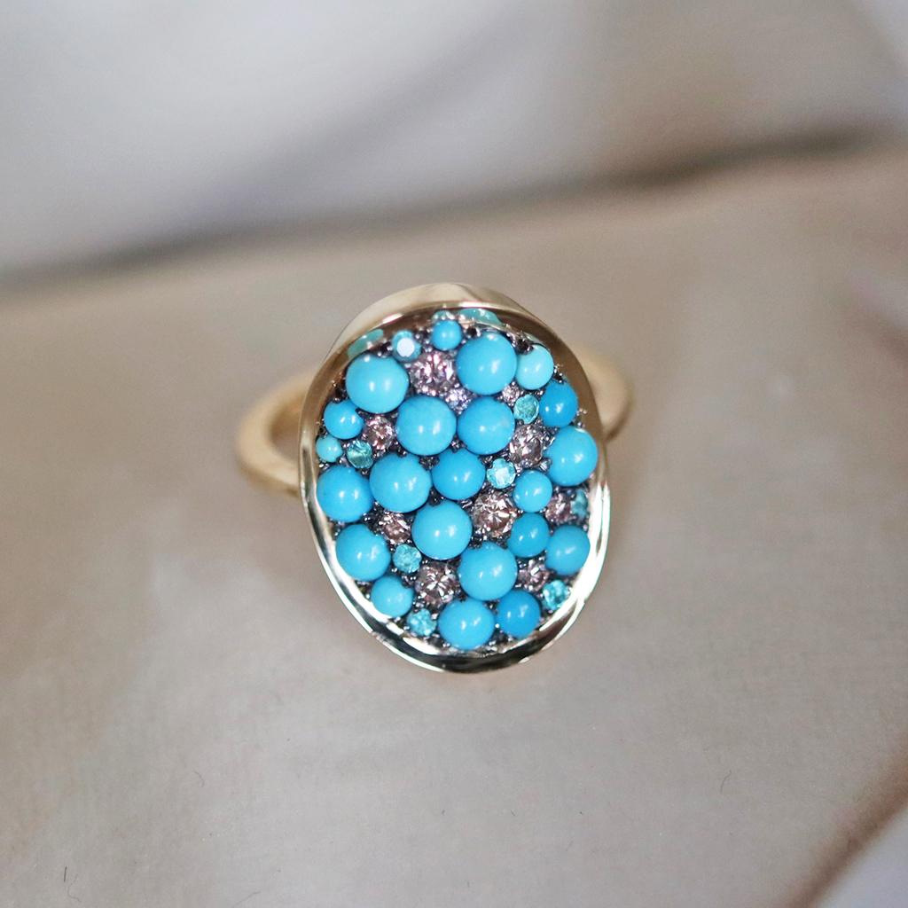 One of a kind ring handmade in Belgium by jewellery artist Joke Quick, in 18K yellow gold 5,8 g & blackened sterling silver 2,5 g (The stones are set on silver to create a black background for the stones. The ring is pave set with:
22 x Turquoise