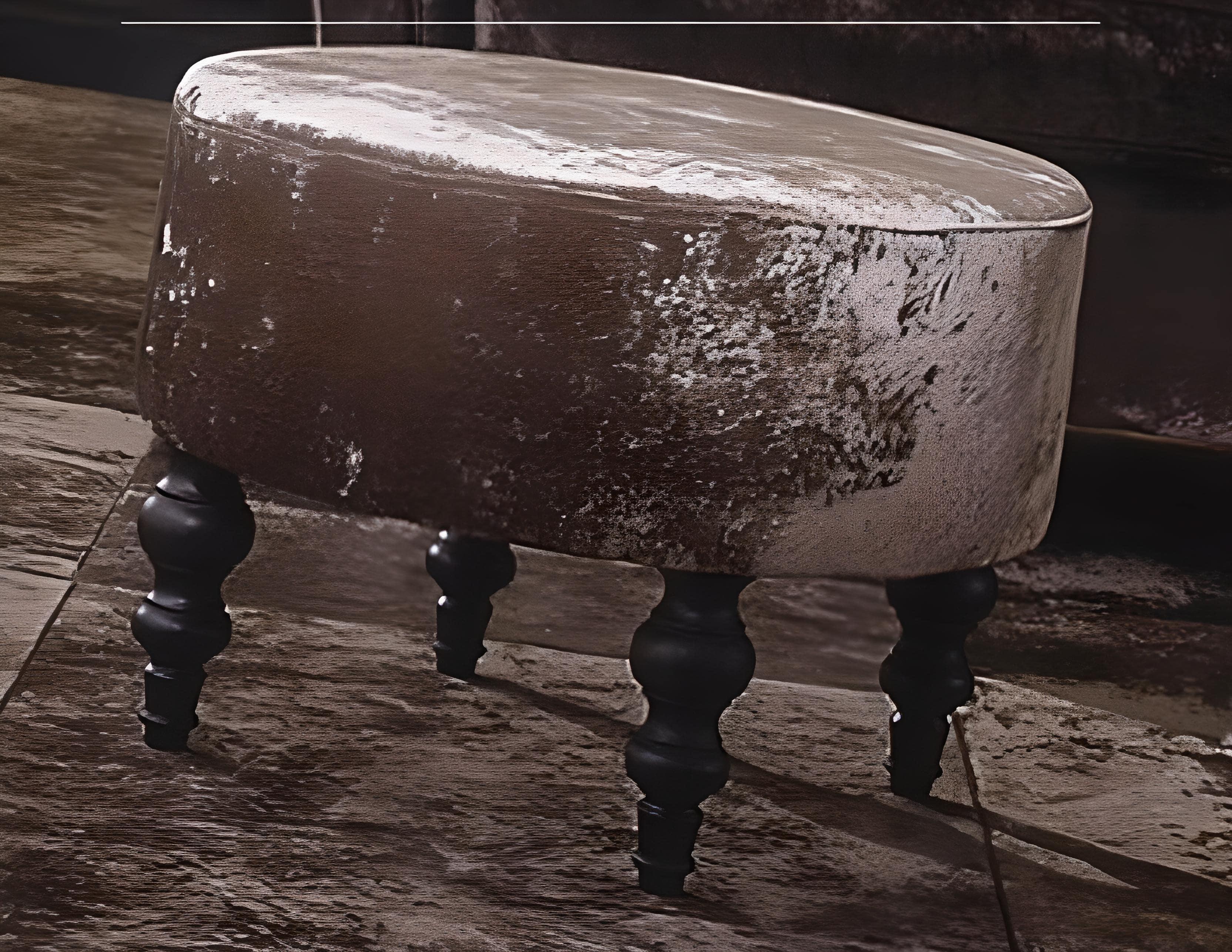 Crafted with turned solid wood legs in a rich carob finish, this ottoman stands as a testament to both quality craftsmanship and eclectic design. The round seat, enveloped in sumptuous velvet, not only promises a luxurious seating experience but