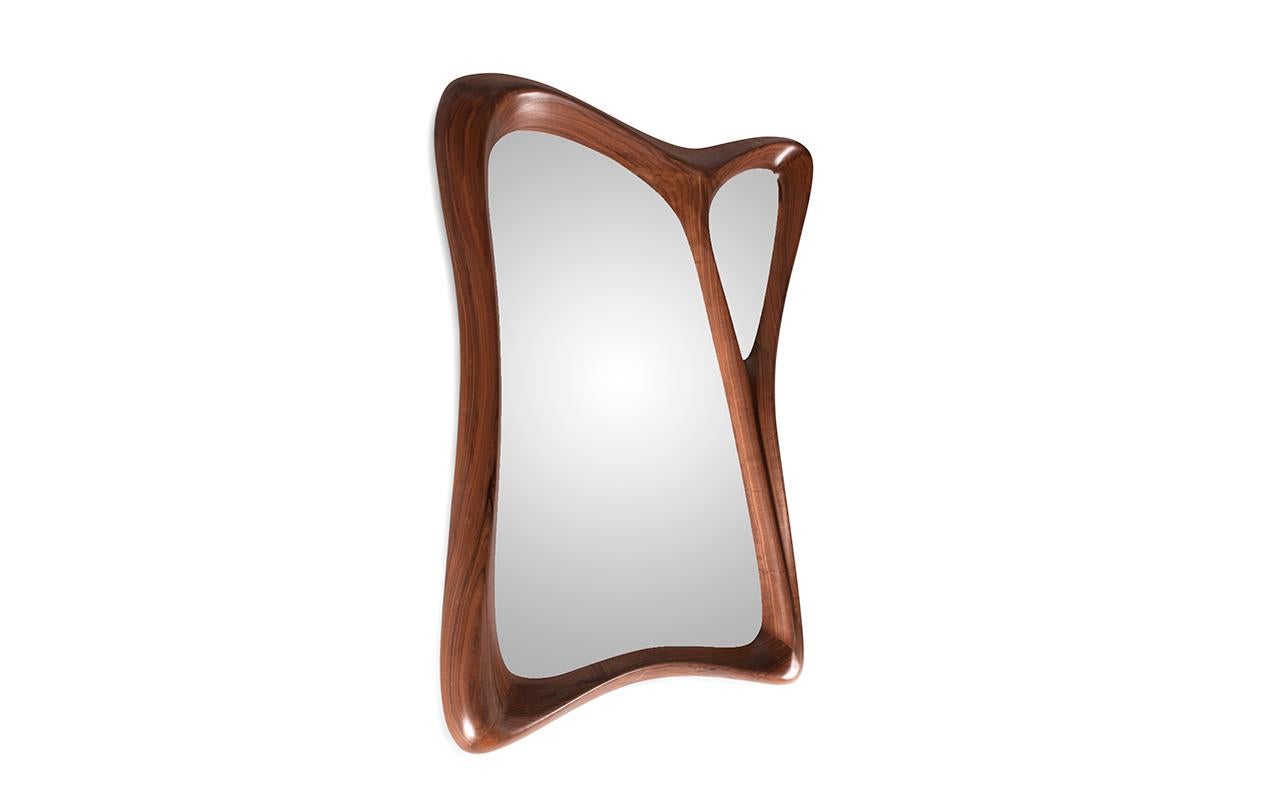 Julie is a one-of-a-kind organic shape rectangular mirror frame that adds a touch of uniqueness to any modern or contemporary home. This mirror frame is designed with a distinctive form that stands out from traditional rectangular frames. It is