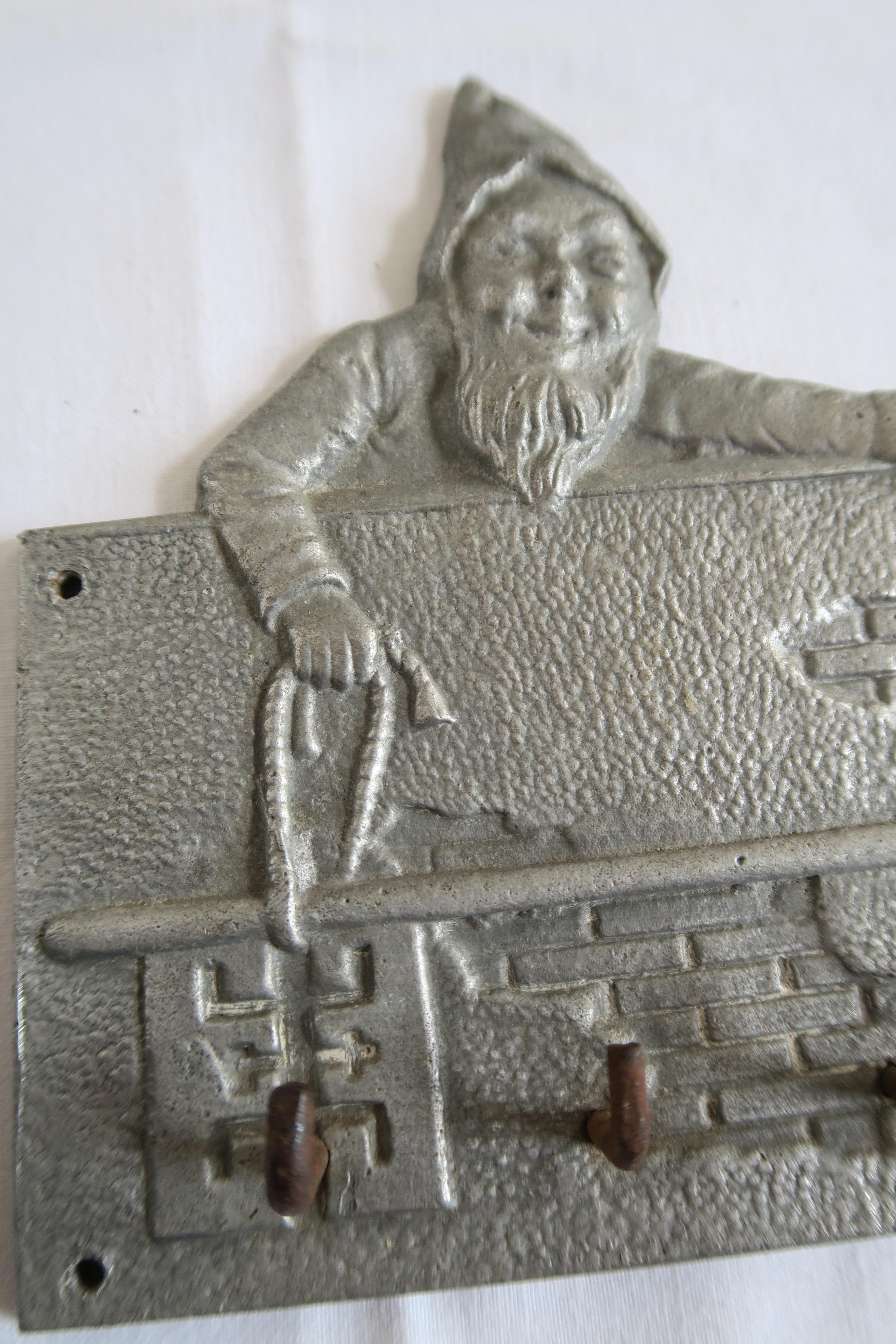 For sale is a unique little keyboard/coat rack featuring two jolly dwarves dutifully guarding your keys. It was handcrafted in the 1930s and is made of solid aluminum-iron alloy. Can be used as a key board for your garden house or, alternatively, it