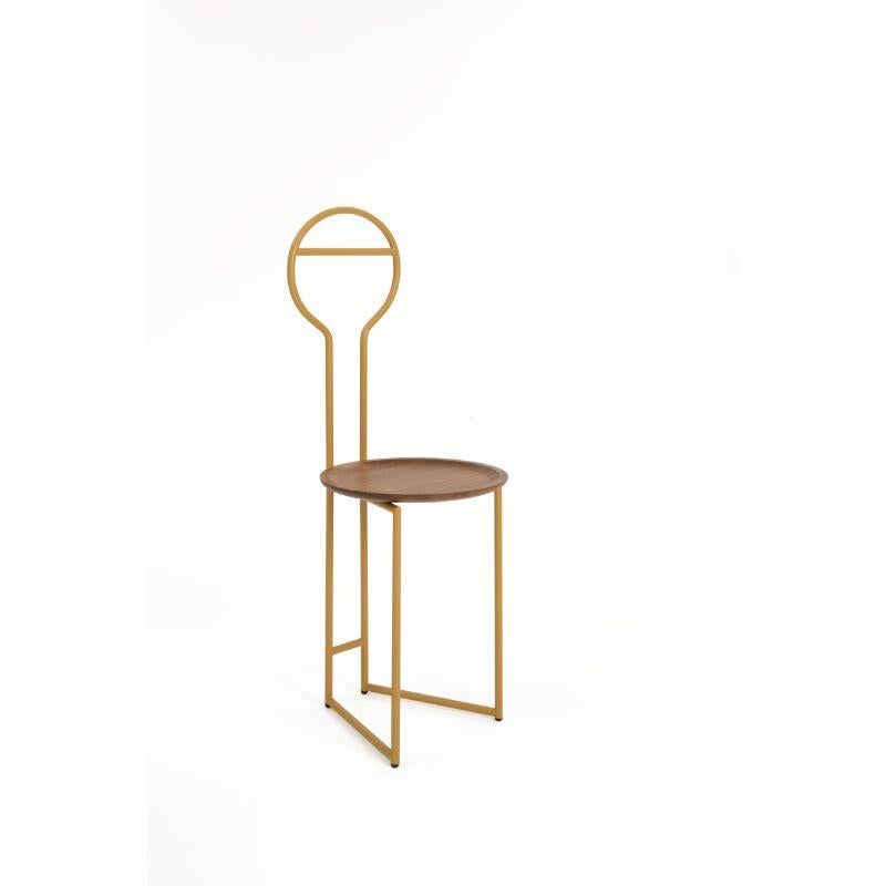 Joly HB Dumb waiter, high back & gold painted with Canaletto by Colé Italia with Lorenz&Kaz (2019)
Dimensions: H.105/seat H. 45 D.38 W.40 cm
Materials: Tubular Steel, Bent and Powder Painted. Wooden Seat in Canaletto walnut
Finishing: GD gold; BK