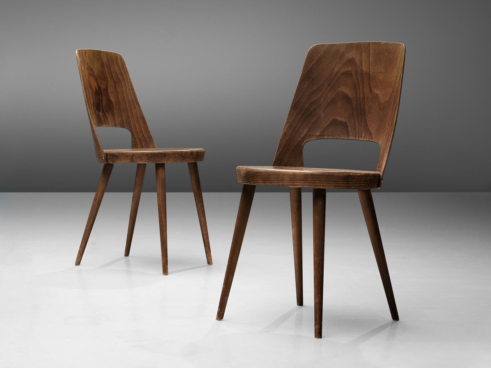 Jomaine Baumann, pair of 'Mondor' dining chairs, plywood, wood, France, 1960s

The ‘Mondor’ dining chair was manufactured by French furniture maker Jomaine Baumann. Characteristic for the ‘Mondor’ chair is the curved bentwood back with a