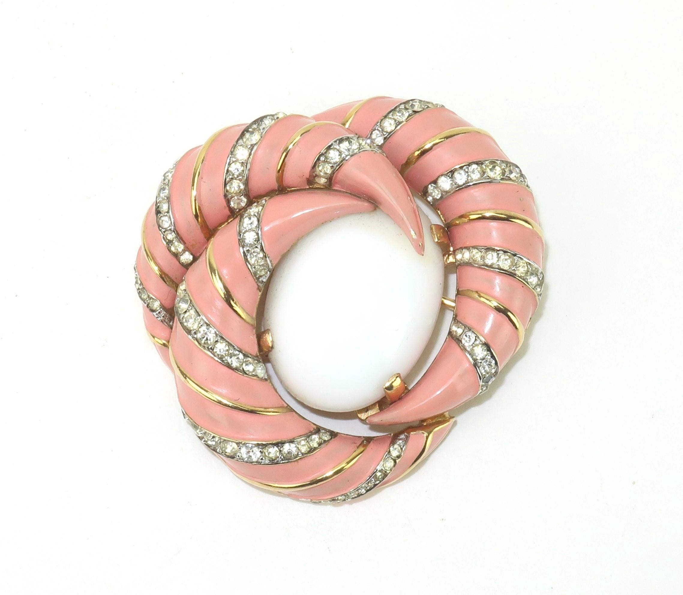 Jomaz put the fabulous in faux with their lovely costume jewelry creations that mirror the quality and style of fine jewelry.  This striking brooch combines a milk glass cabochon center stone surrounded by a crescent shaped coral pink enameled gold