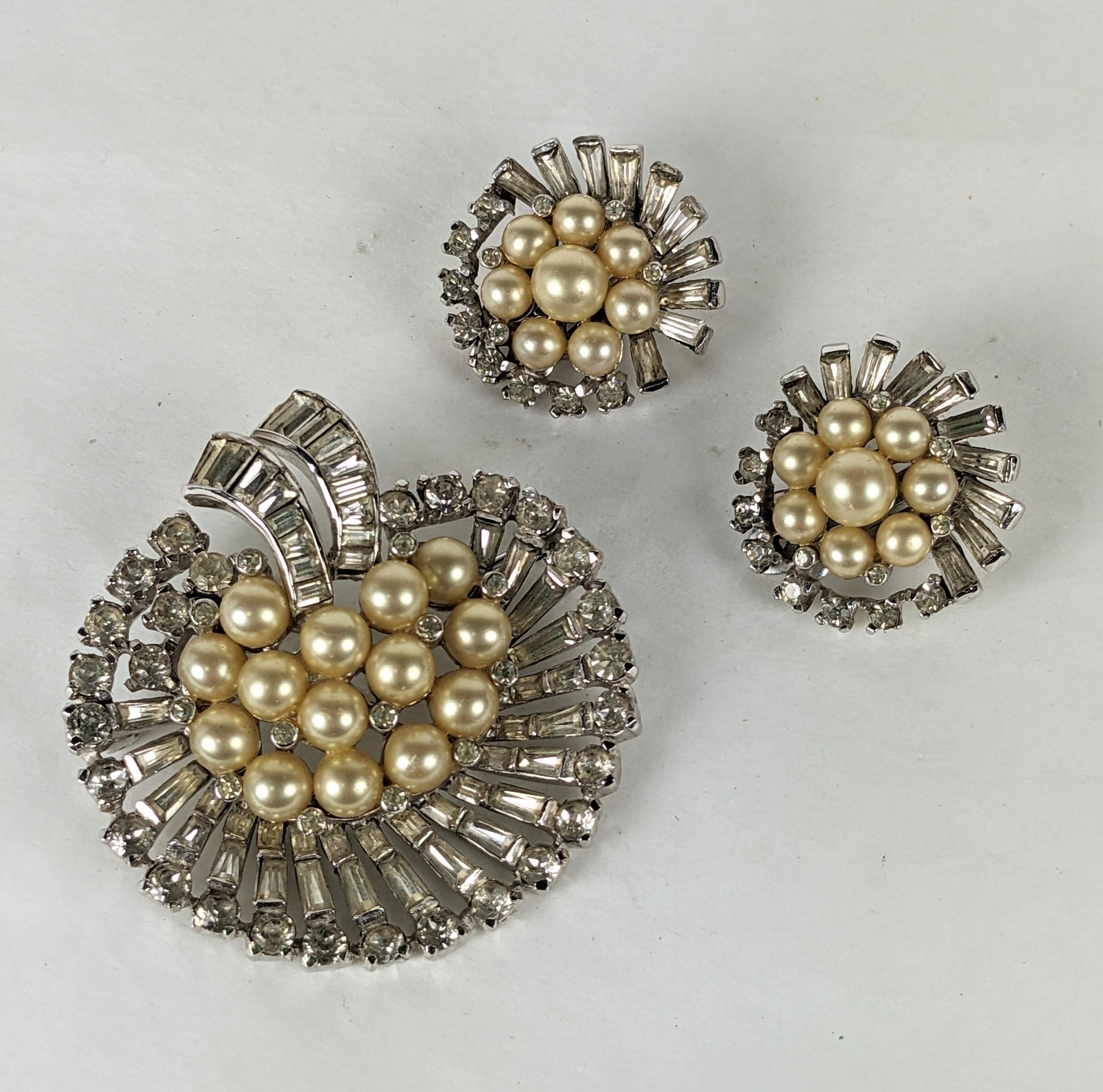 Elegant Jomaz Pearl and Pave Baguette Brooch and Earrings from the 1950's. Swirl design brooch with elaborate round and baguette crystal work. Matching clip earrings. 
Jomaz by Mazer. 2