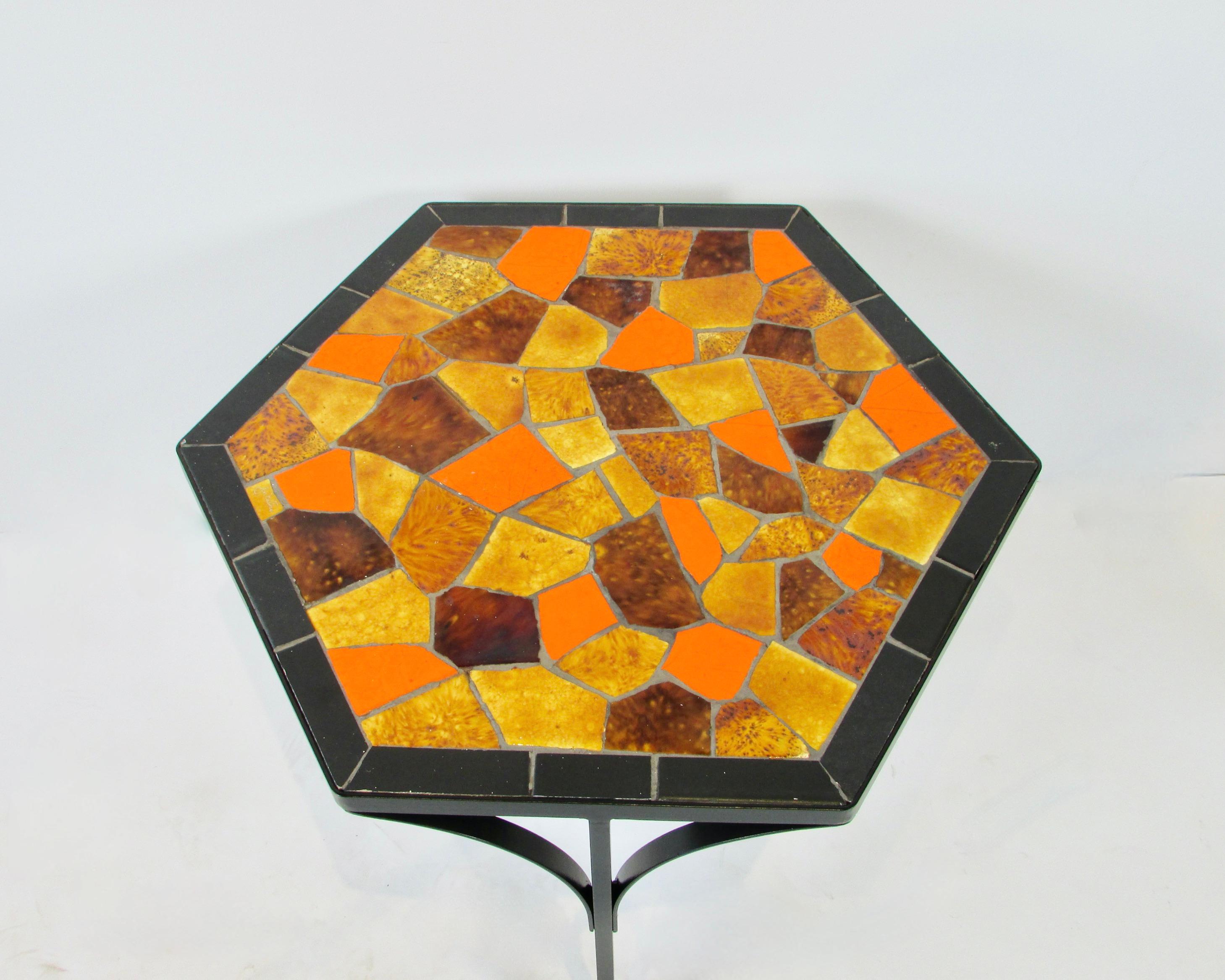 Set of four Jon Matin hexagon shape tile top tables. Included are a pair of matching large tables 23.75 x 20.75 x 18.5 tall. Two graduated tables that will nest or stack under the larger. 
Three wrought iron legs support bright and colorful tiles